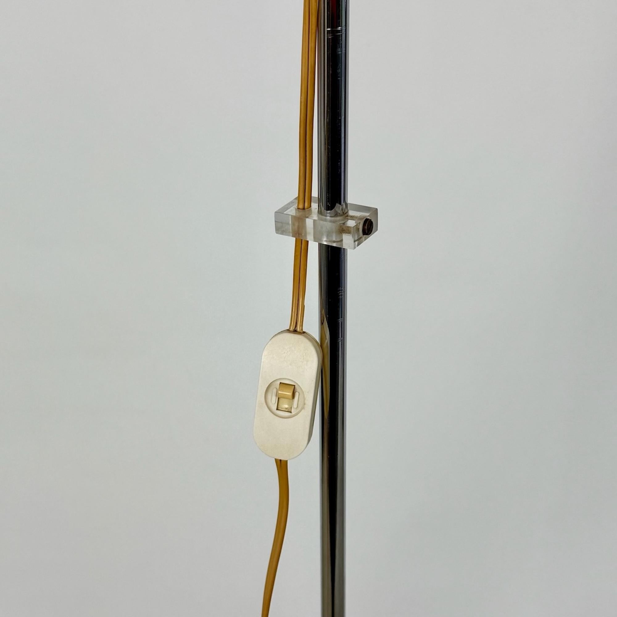 Elevate your space with the timeless elegance of the Harvey Guzzini Faro Floor Lamp, a masterpiece of 70s Italian design. With its sleek chrome rod, understated round base, and vibrant orange acrylic mushroom shade, this lamp embodies mid-century