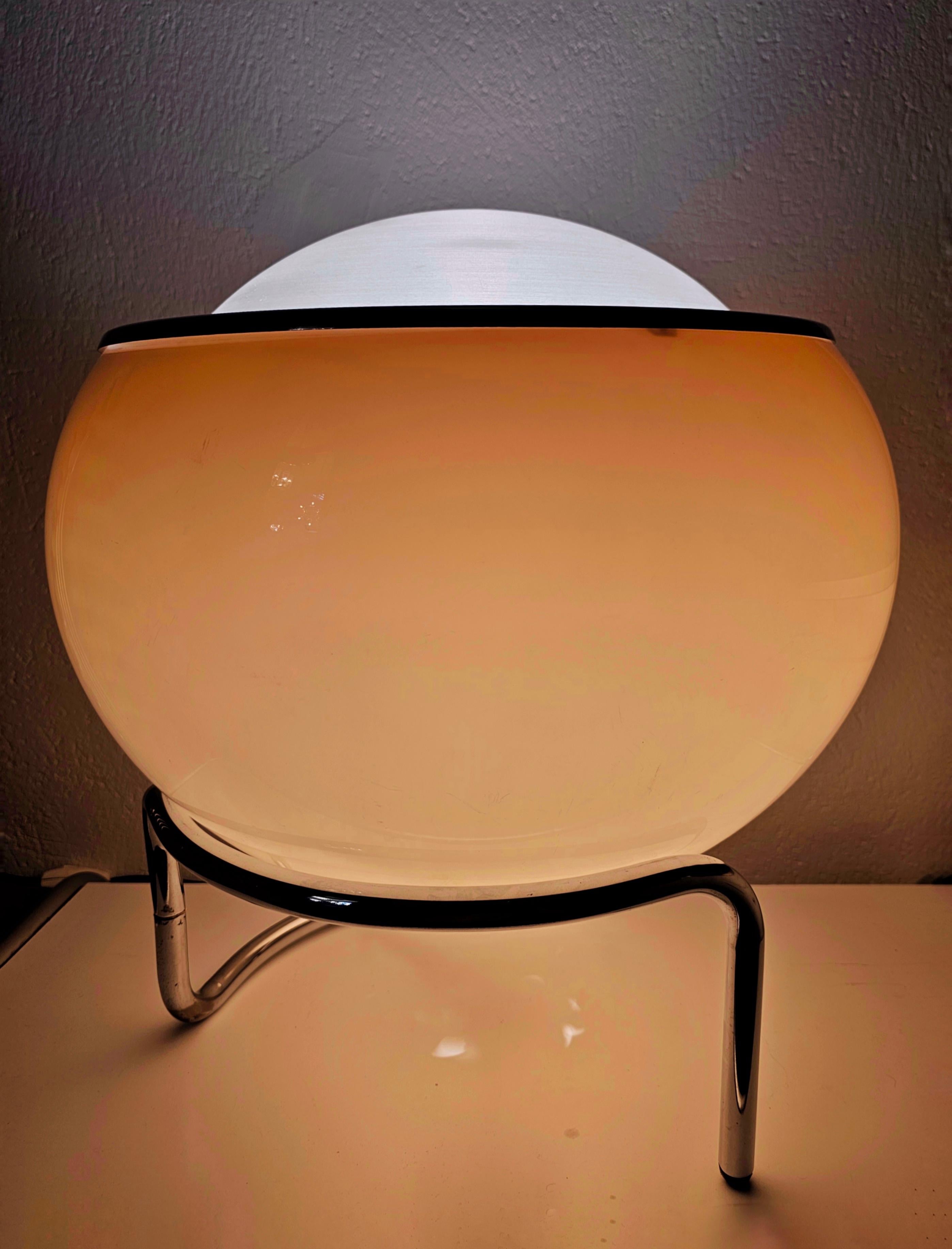 This listing features an astonishing and extremely hard to come by accent lamp by Harvey Guzzini, Model Clam. it was designed by Studio 6G and manufactured by Meblo. it features an infinity chrome stand which holds the Buf Grande shade done in