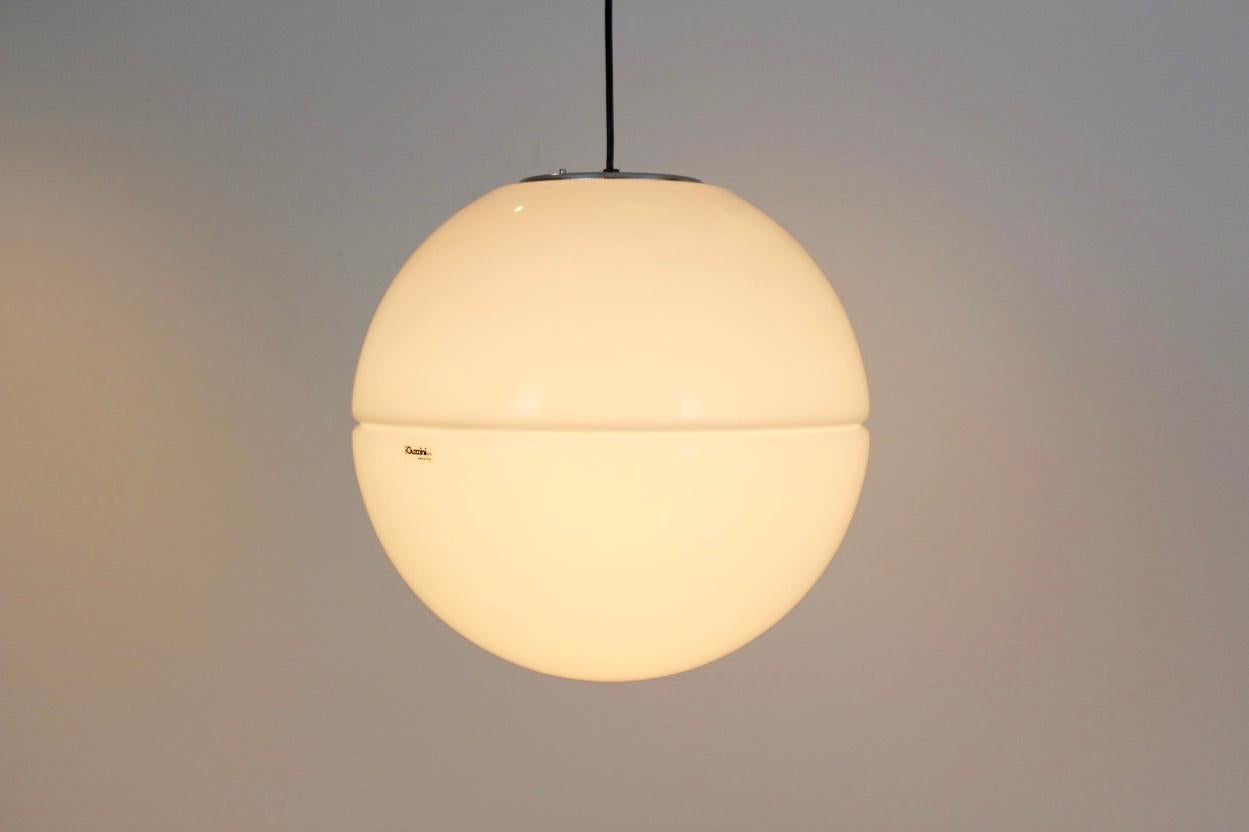 Beautiful midcentury pendant light designed by Harvey Guzzini in the 1960s and manufactured by Guzzini in Italy. It is made from white plexiglass and aluminium. The lamp remains in a very good vintage condition.