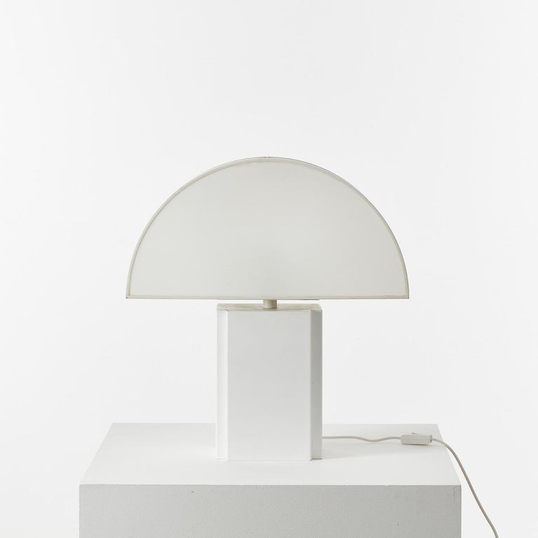 Large Olympe table lamp designed by Harvey Guzzini for ED, Italy, 1970s. The demilune shade is particularly pleasing lit, a half-moon of ambient light through semi-opaque acrylic. It has a metal base and a plastic shade, open at the back for ease of
