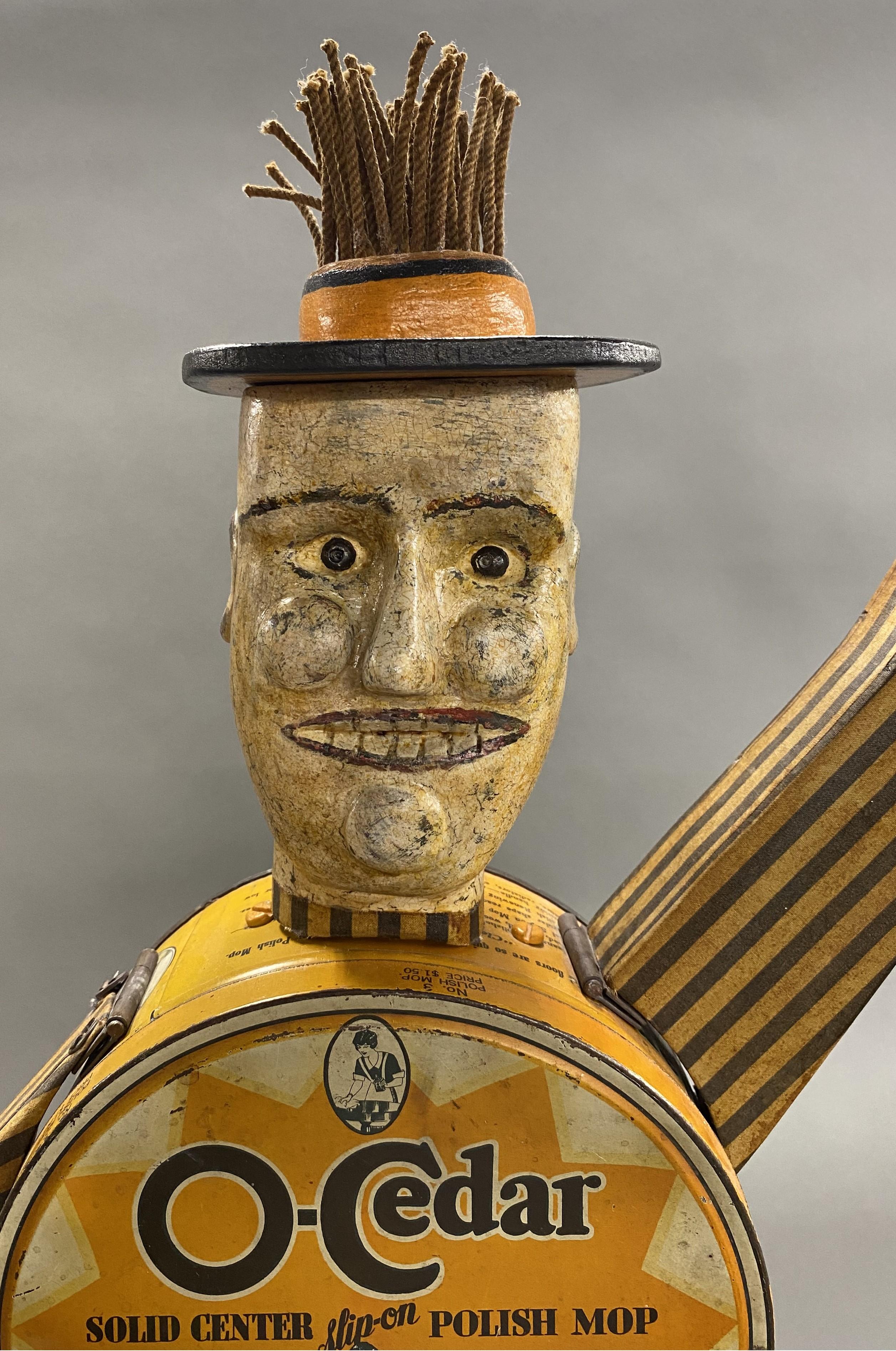 A wonderful figural folk art sculpture of an O’Cedar Mop Man by contemporary Maine artist Harvey Peterson (20th/21st c). Peterson was born in Seattle, WA, and got his a BFA and MFA from the Maryland Institute College of Art. Harvey spent over 2