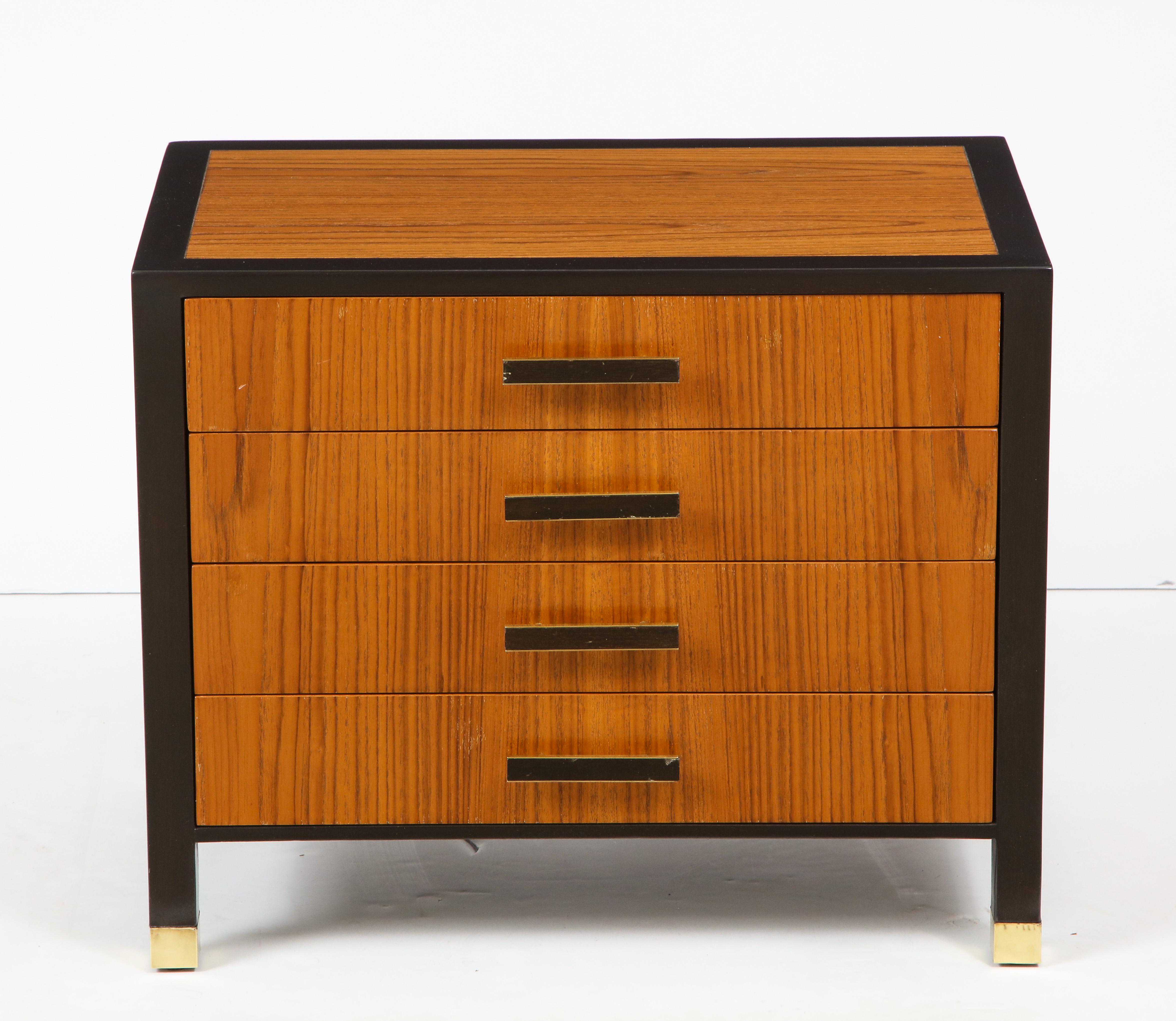 Pair of midcentury nightstands with classic styling, featuring rosewood panels banded in ebonized mahogany, each having 4 drawers which provide ample storage. Door pulls and legs trimmed in satin brass. Signed.