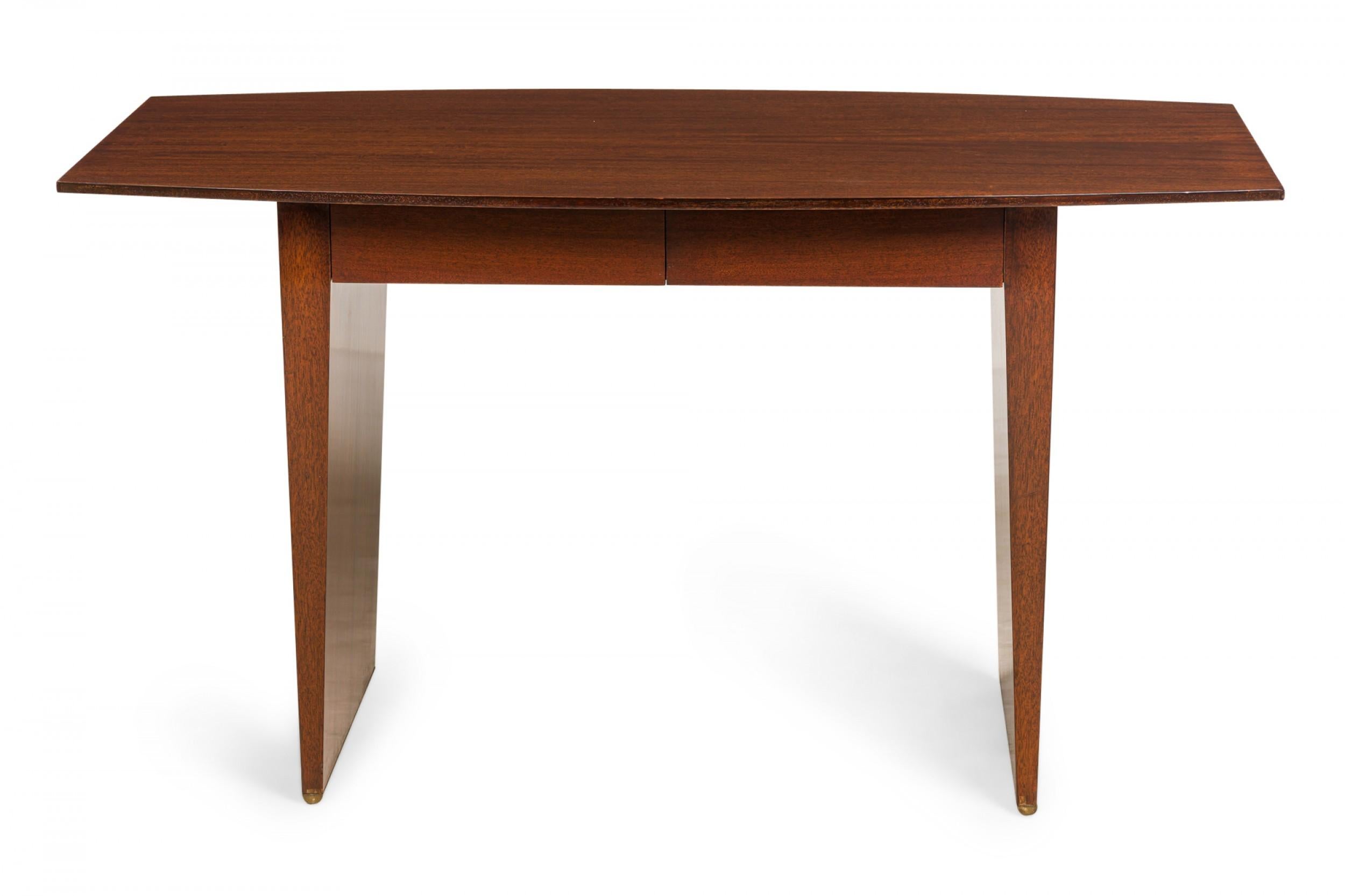 American Mid-Century polished walnut table desk with a 'boat' form top resting on a bracket-shaped walnut base. (HARVEY PROBBER)
