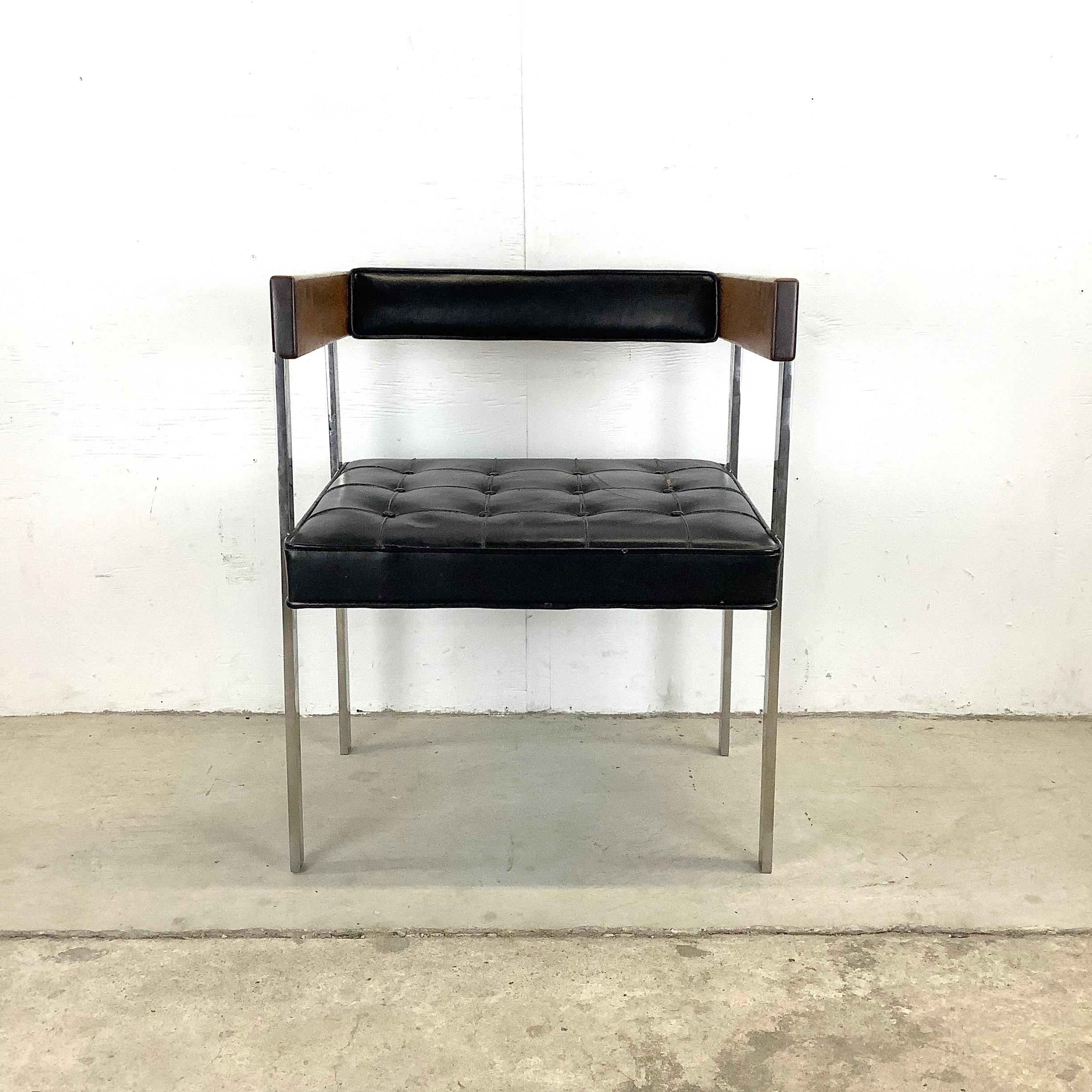 This unique design from the Harvey Probber architectural line is titled Chair 249. The mirrored polish stainless steel legs and solid wood frame add weight to this substantial mid-century armchair. The cube like seat back is accented by the dark