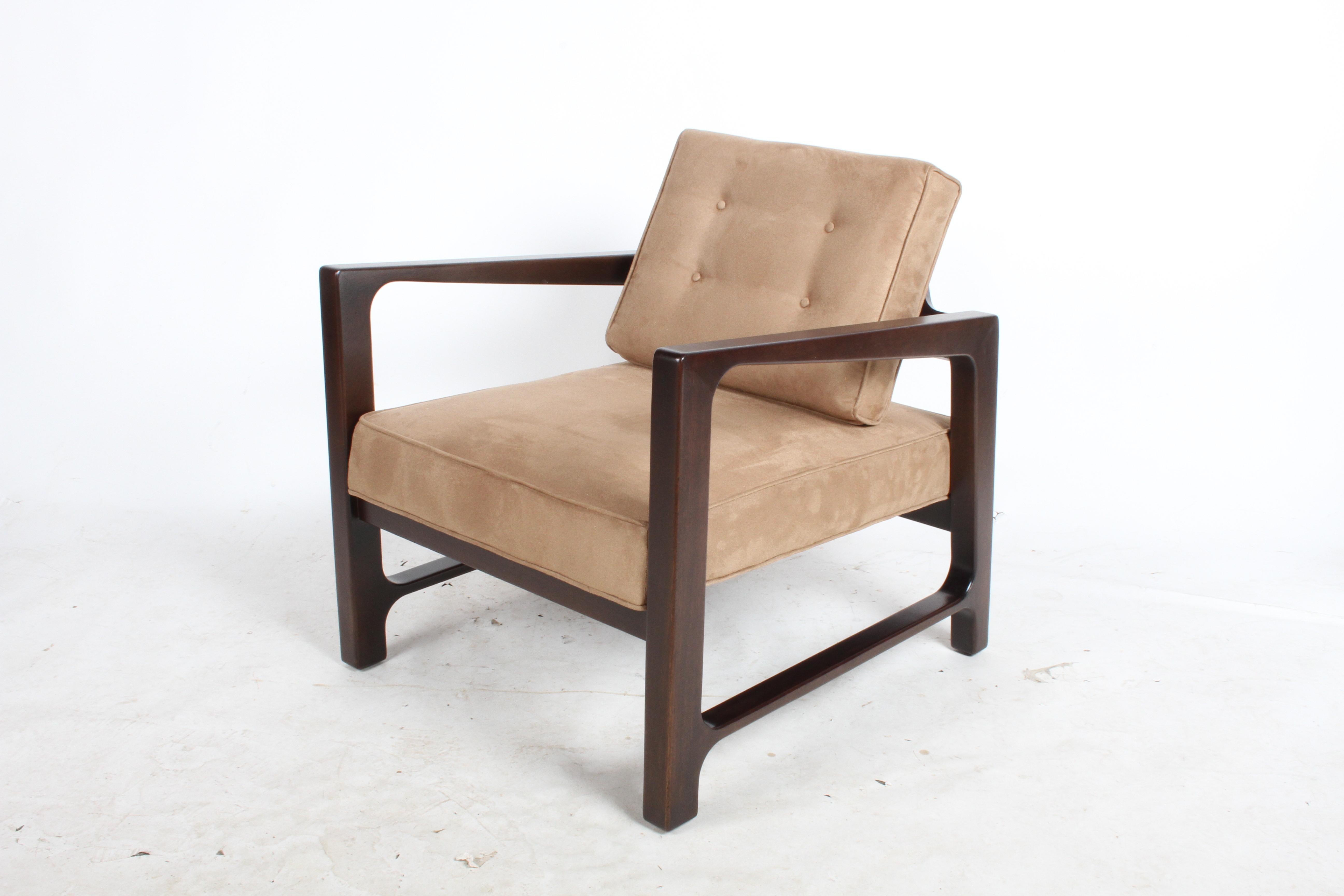 Classic Probber designed lounge chair that evokes the true spirit of the Mid-Century Modern movement. The mahogany frame has been refinished in a medium espresso stain and reupholstered in a tan suede. Probber and Edward Wormley for Dunbar have a