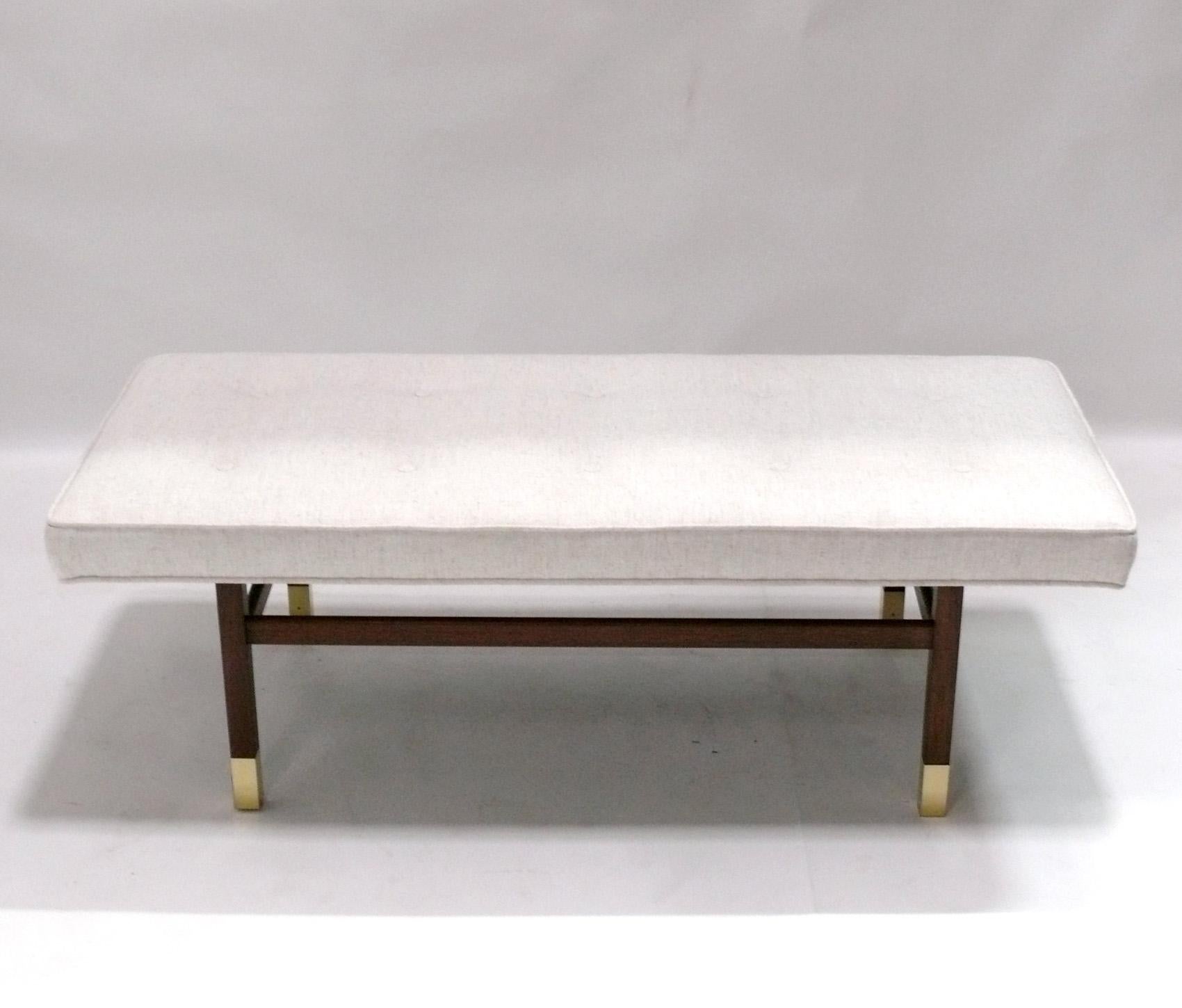 Clean Lined Mid Century Walnut Bench, attributed to Harvey Probber, unsigned, American, circa 1960s. It has been recently reupholstered in an ivory color herringbone fabric with all new foam.