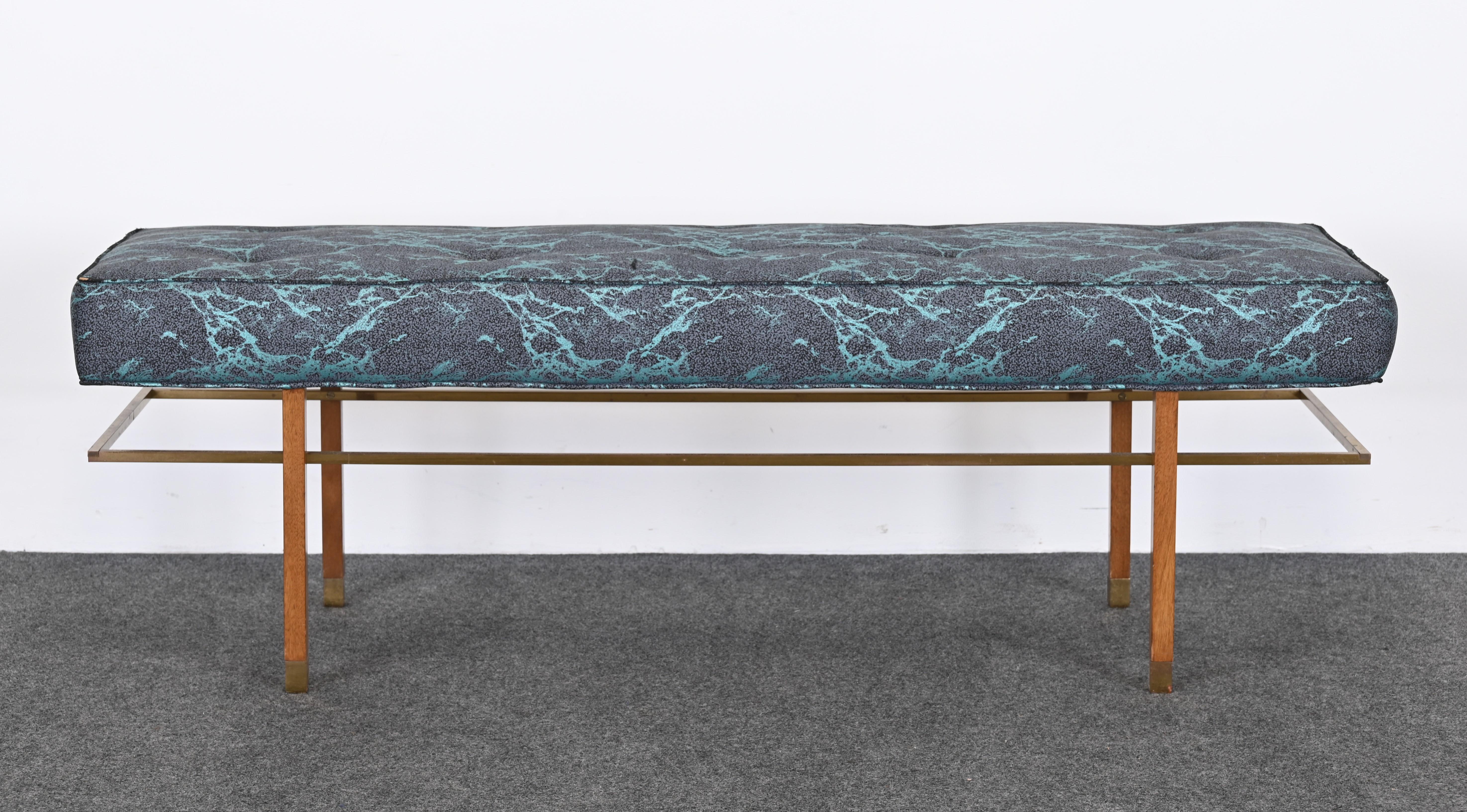 A minimalist designer bench by Harvey Probber, 1955. This modern bench has brass accents and mahogany legs. The solid brass accents can be polished but are presently patinated and in vintage condition. The upholstery is also vintage, new upholstery