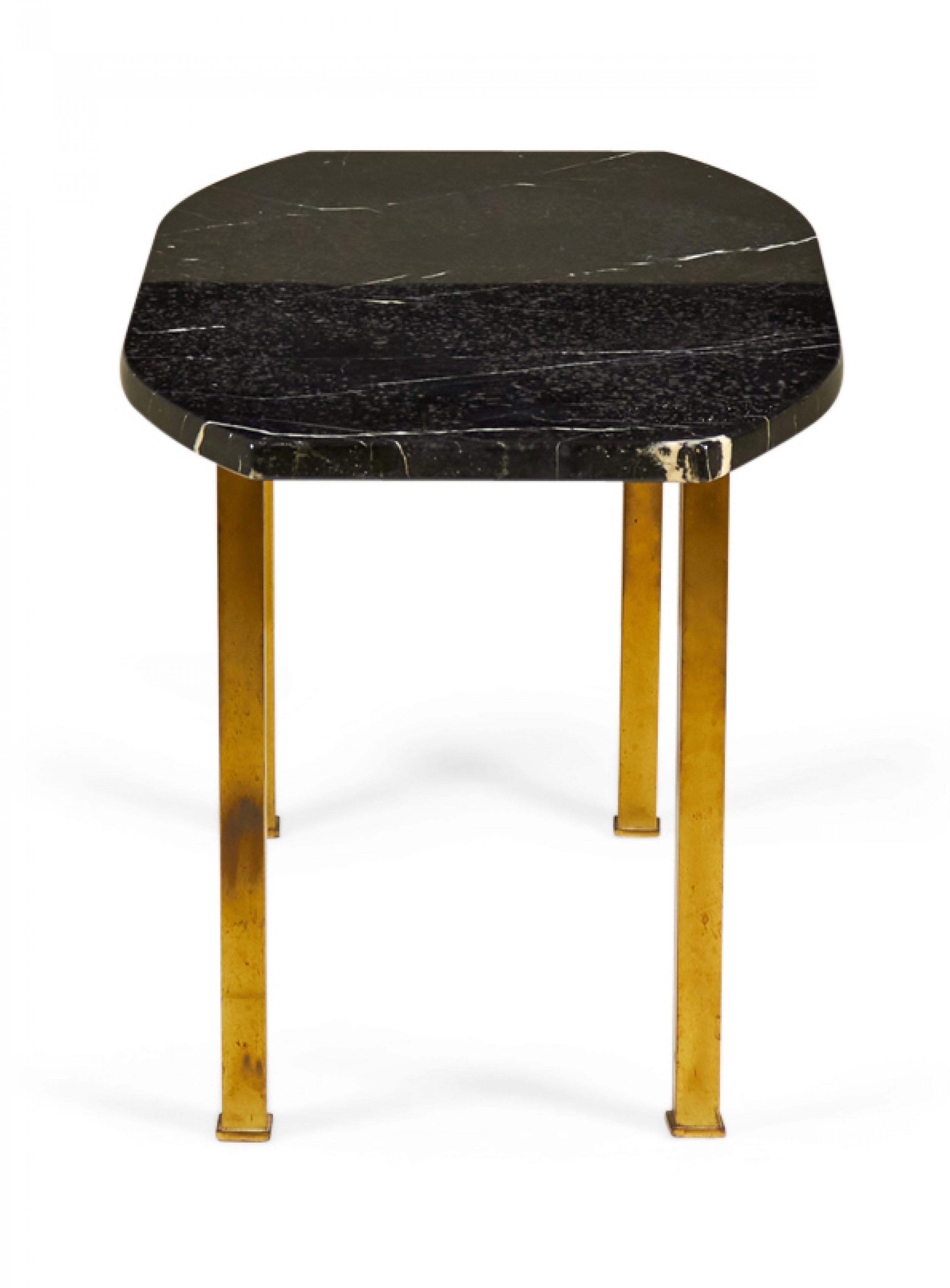 American Mid-Century coffee / cocktail table with an oval-shaped black marble top with canted ends resting on four square brass legs. (HARVEY PROBBER)
