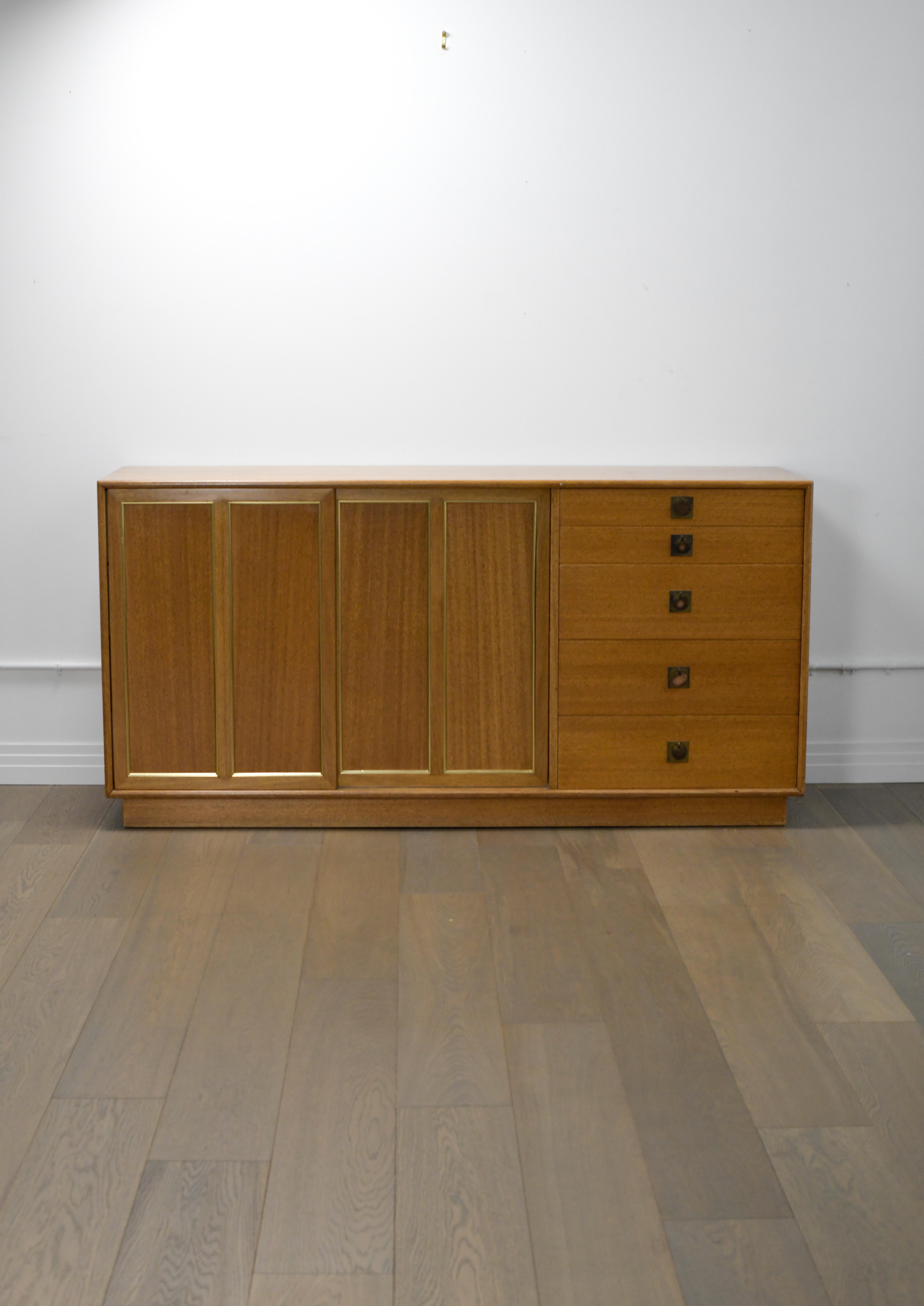 Bleached Mahogany Credenza by Harvey Probber. 

This credenza is in good vintage condition and has a patina commensurate with its age. Four white accent drawers can be revealed by sliding the left door to the middle, giving this piece the ability to