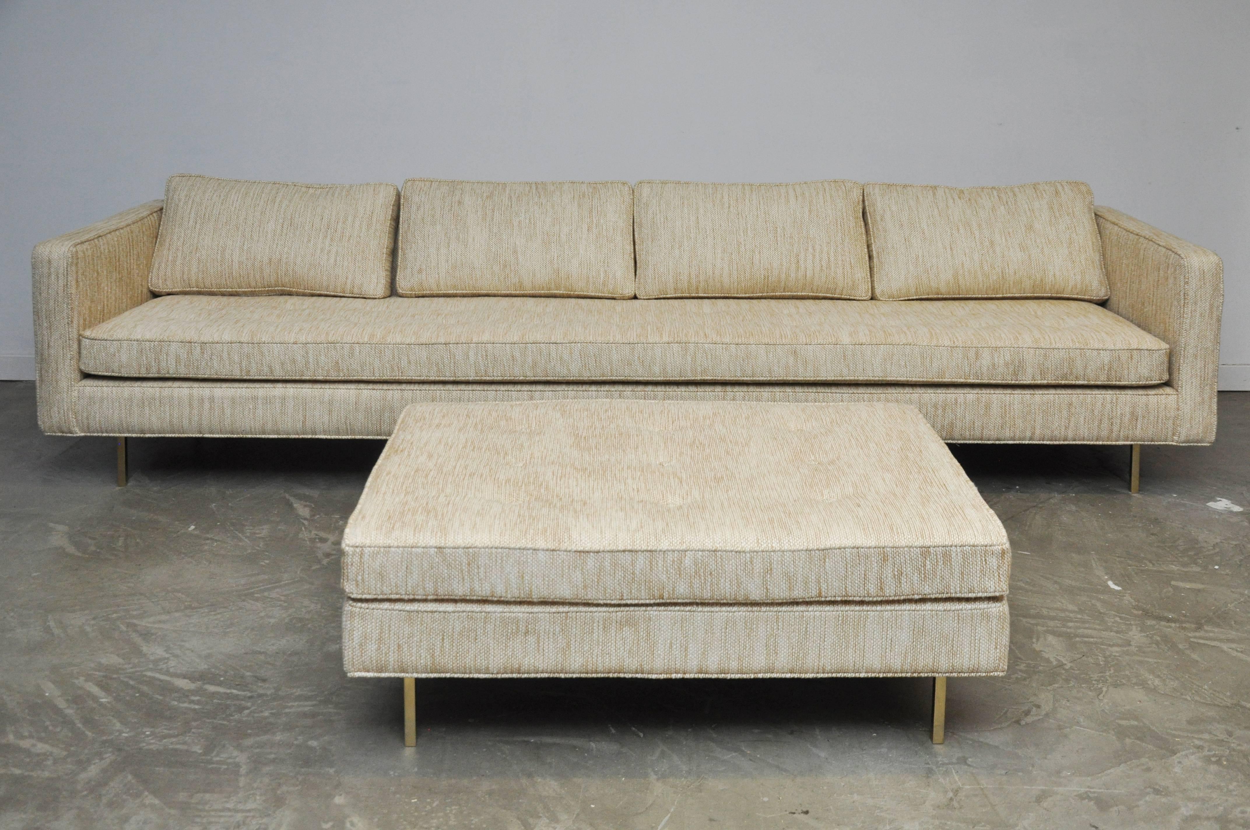 Even arm sofa with matching ottoman by Harvey Probber. Fully restored.  Beautiful new woven fabric, new foam and feathers on polished brass legs.

Measures: Sofa 113 long x 33 deep x 31 tall, 17 seat
Ottoman 42 x 30 x 17 tall.

 