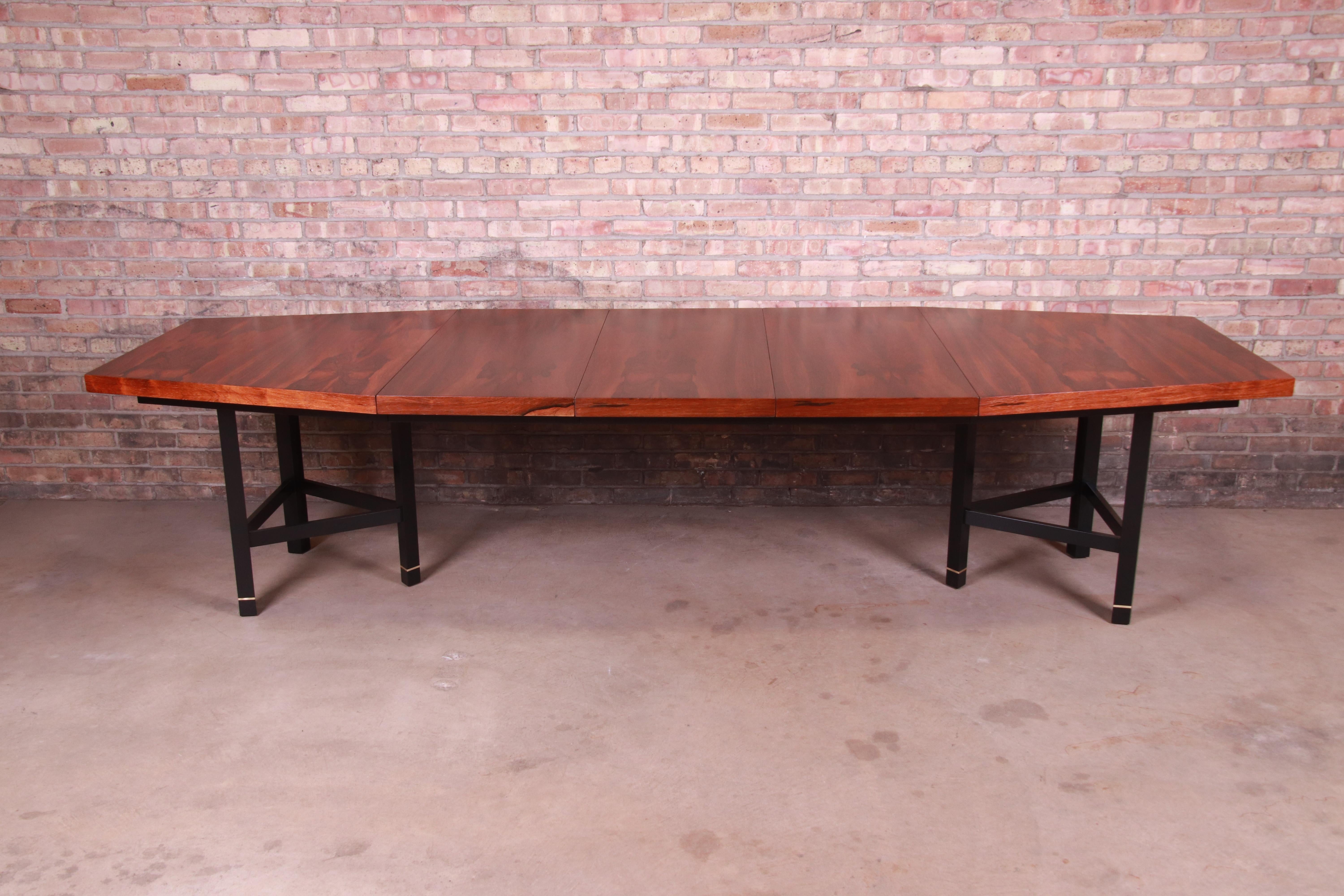 An exceptional Mid-Century Modern boat-shaped extension dining table

By Harvey Probber

USA, circa 1950s

Bookmatched Brazilian rosewood, with ebonized solid mahogany legs and brass accents.

Measures: 65.88