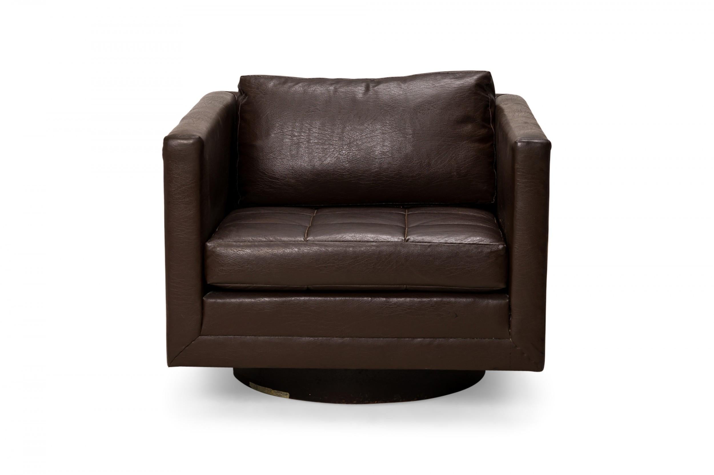 American Mid-Century cube form swivel lounge / armchair with brown vinyl upholstery. (HARVEY PROBBER).
 