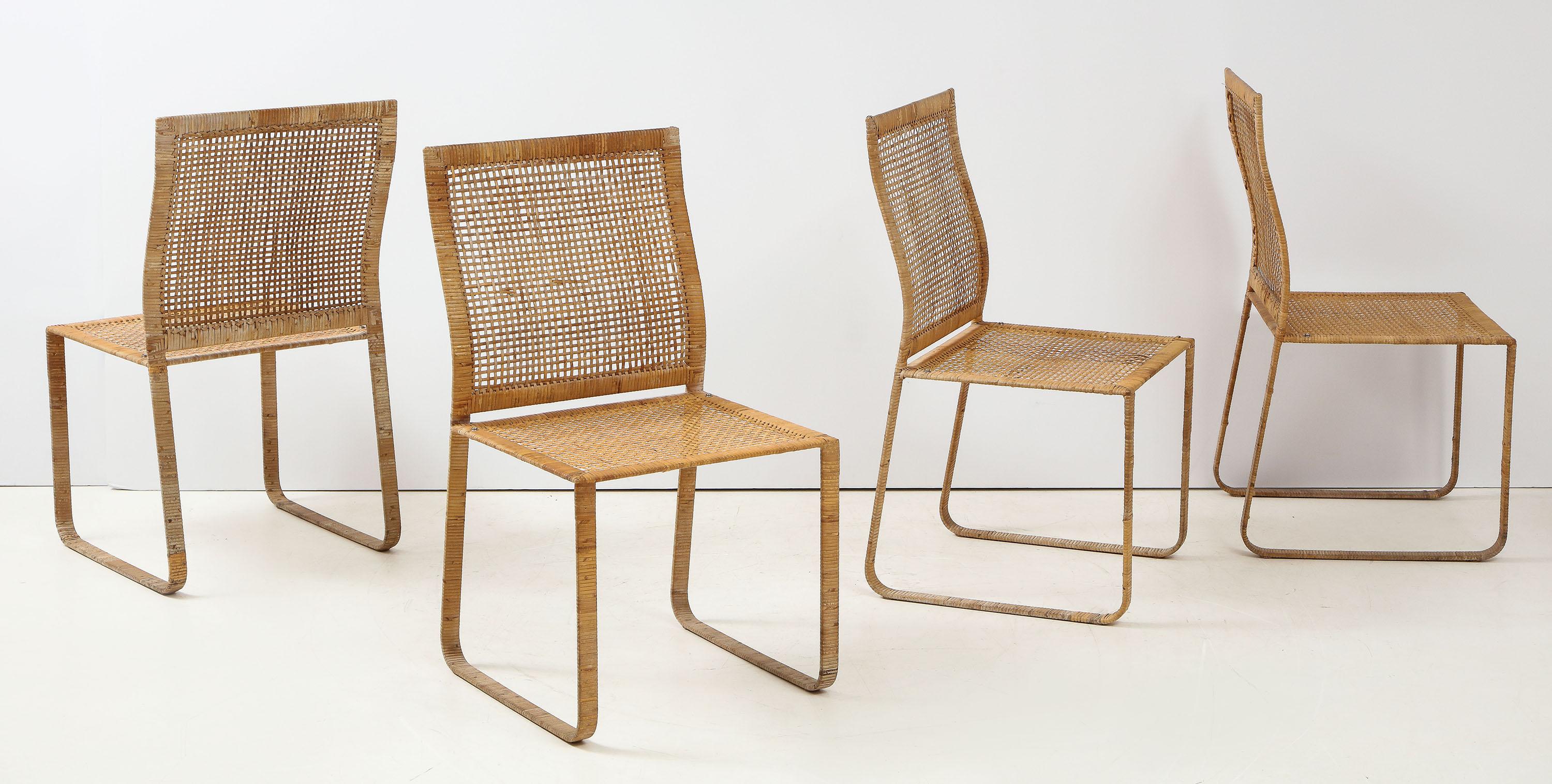 The set of 4 Harvey Probber dining chairs of woven rattan over steel frames. Cushions can be applied with snaps on to the seats.