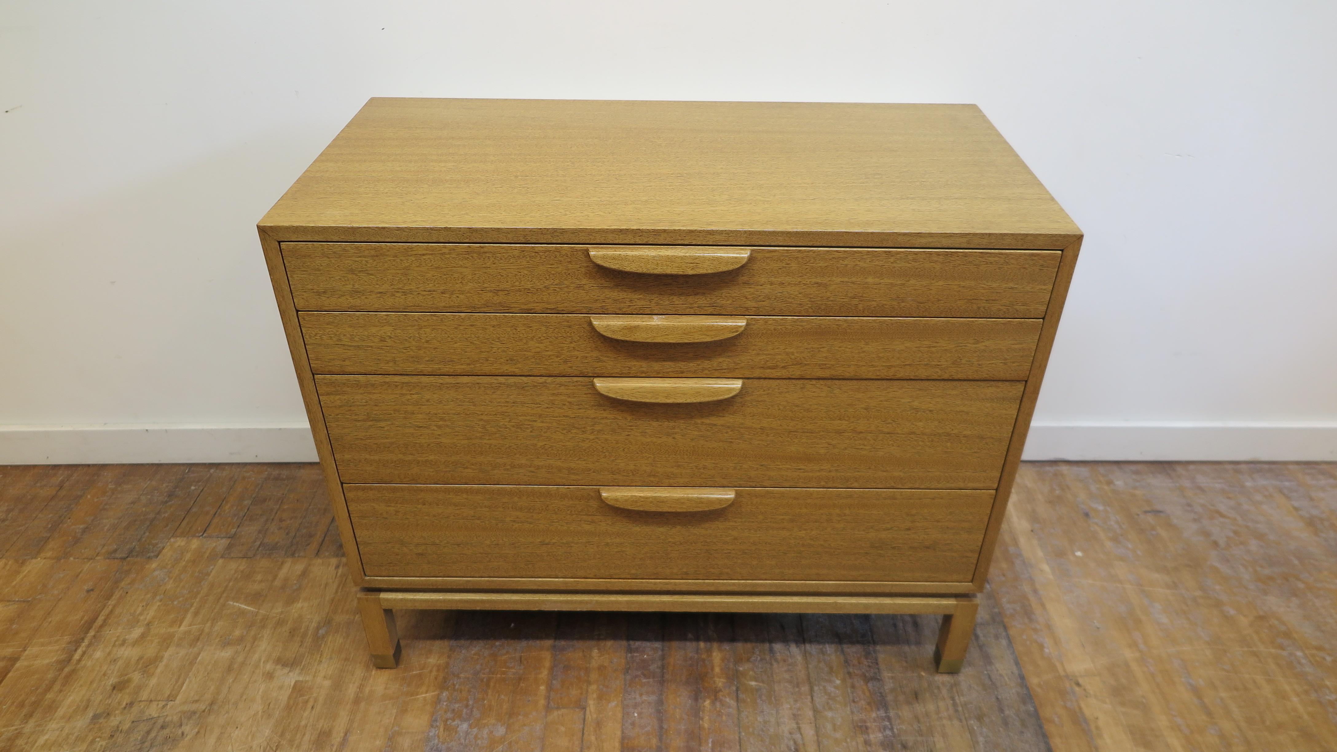 Mid-Century Modern chest of drawers by Harvey Probber. Harvey Probber chest of drawers in bleached mahogany with four drawers brass sabots to the feet. Inside two top drawers have white laminate panel bottom with oak sides, second drawer has
