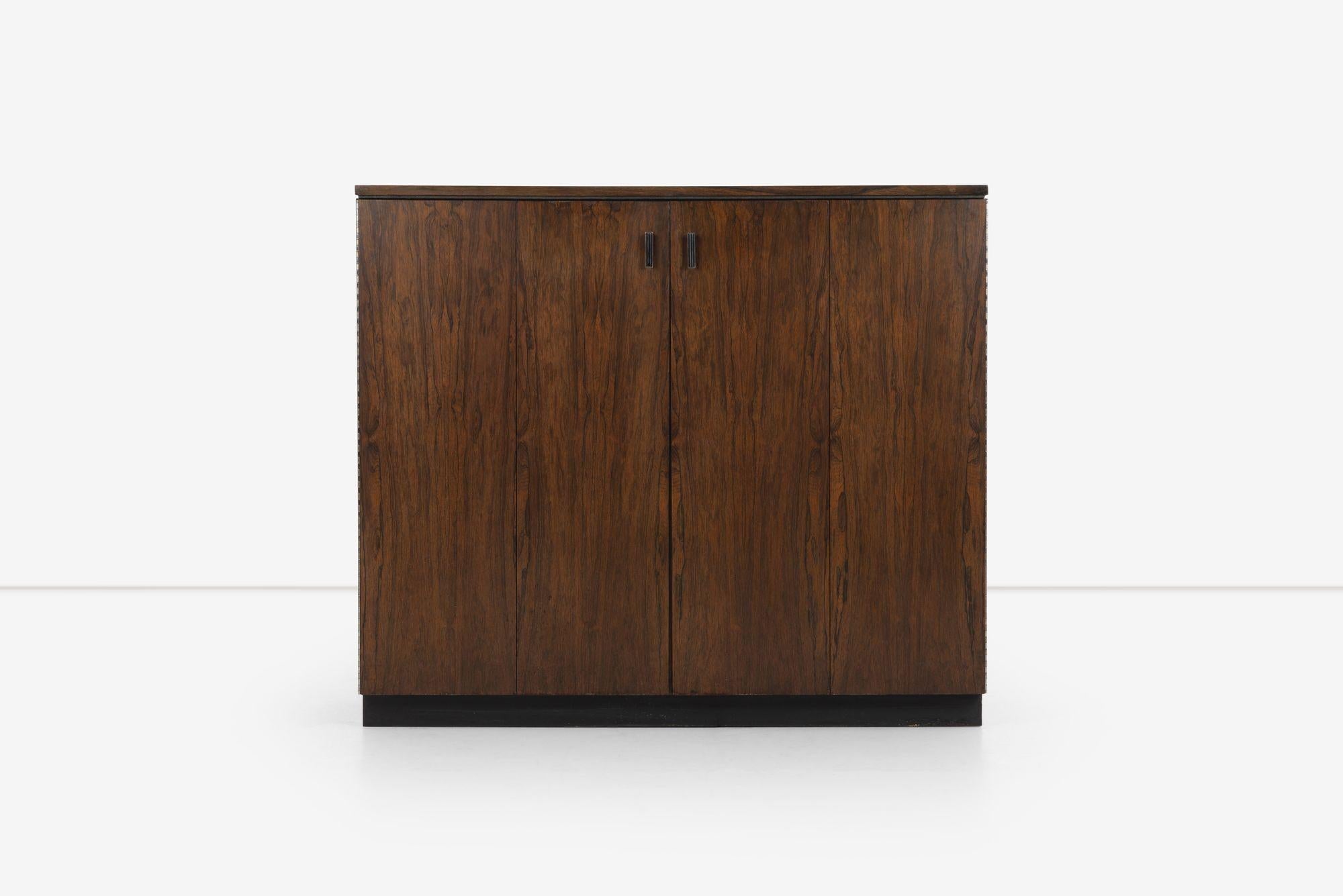 Founders Furniture Chest of Drawers in Rosewood;  features bi-fold doors concealing five drawers with six adjustable, removable shelves on a plinth base.