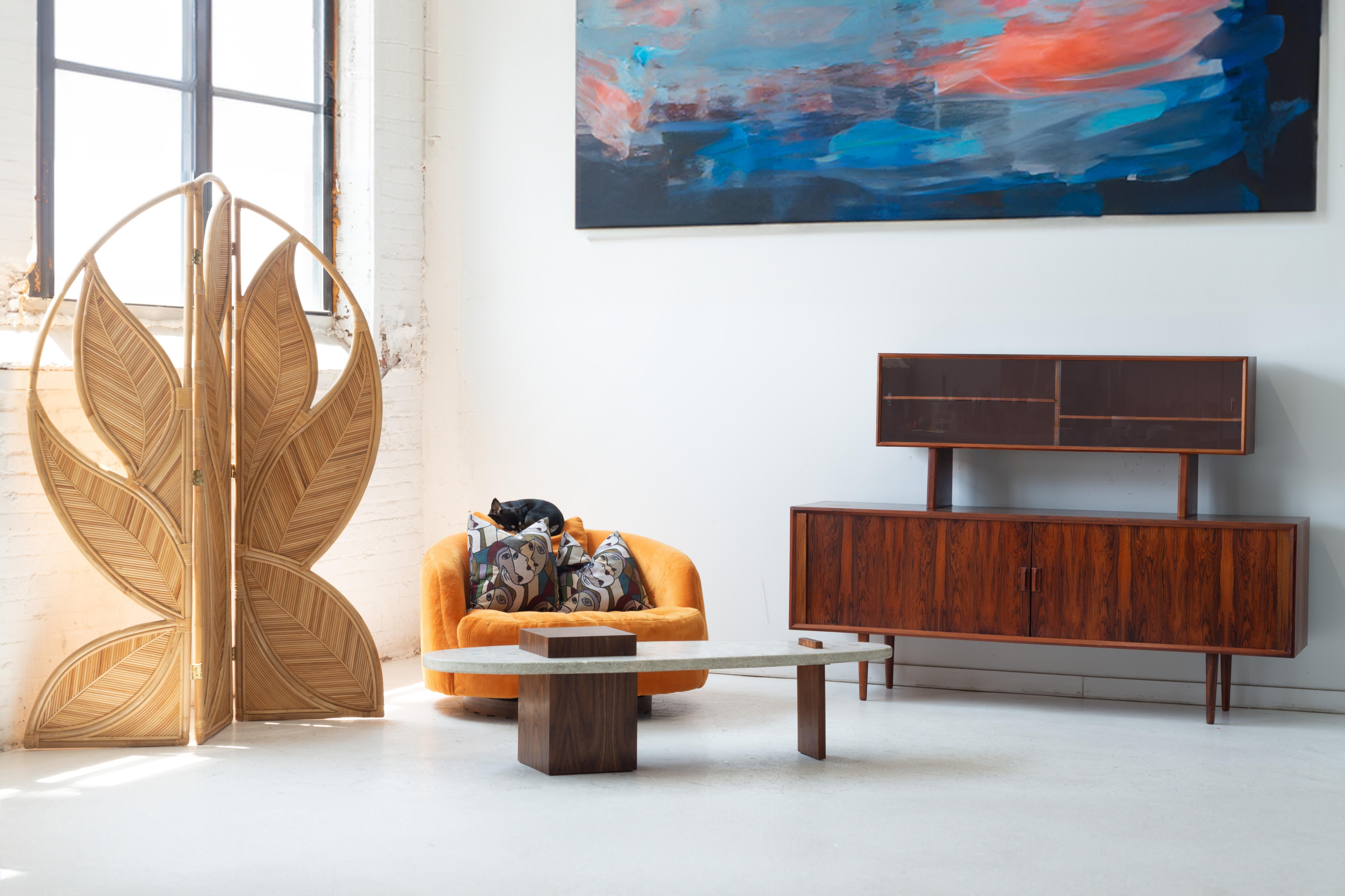 Harvey Probber Terrazzo Cocktail Table, circa 1960s. This sculptural piece features a striking surfboard-shaped terrazzo top—substantial, speckled, and refined. The asymmetrical walnut base plays with balance and form: one end anchored by a hefty