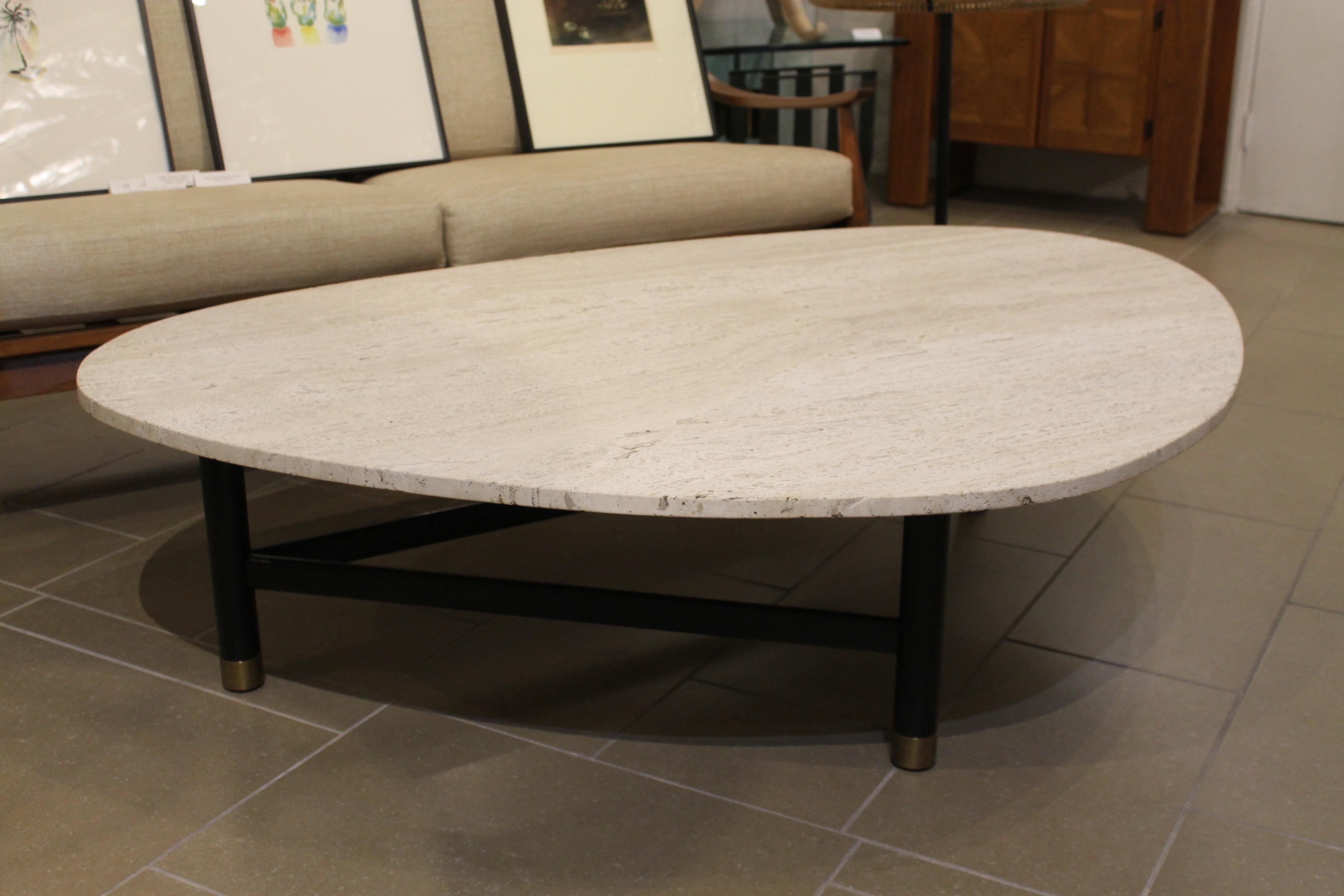 Iconic coffee table by Harvey Probber with triangular shaped travertine top and wood base. Brass caps on feet. Base has been professionally refinished and the travertine top is original to the table. Table measures: 60