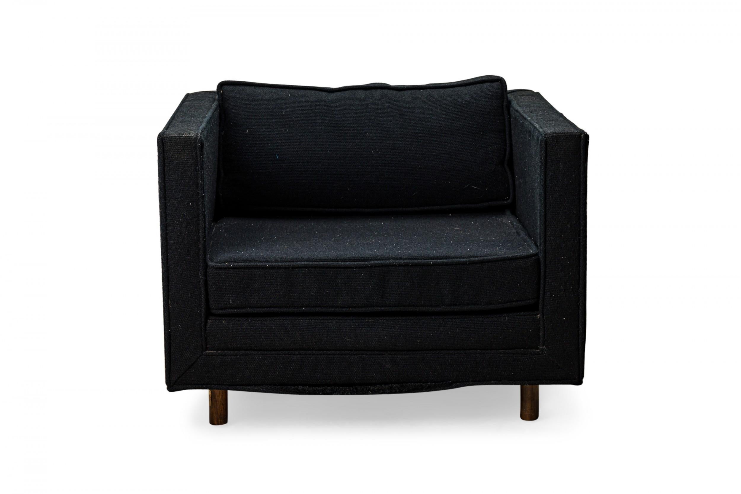 American Mid-Century cube form lounge / armchair with textured black fabric upholstery and a matching removable back cushion. (HARVEY PROBBER)(Available in black: DUF0509A).
 