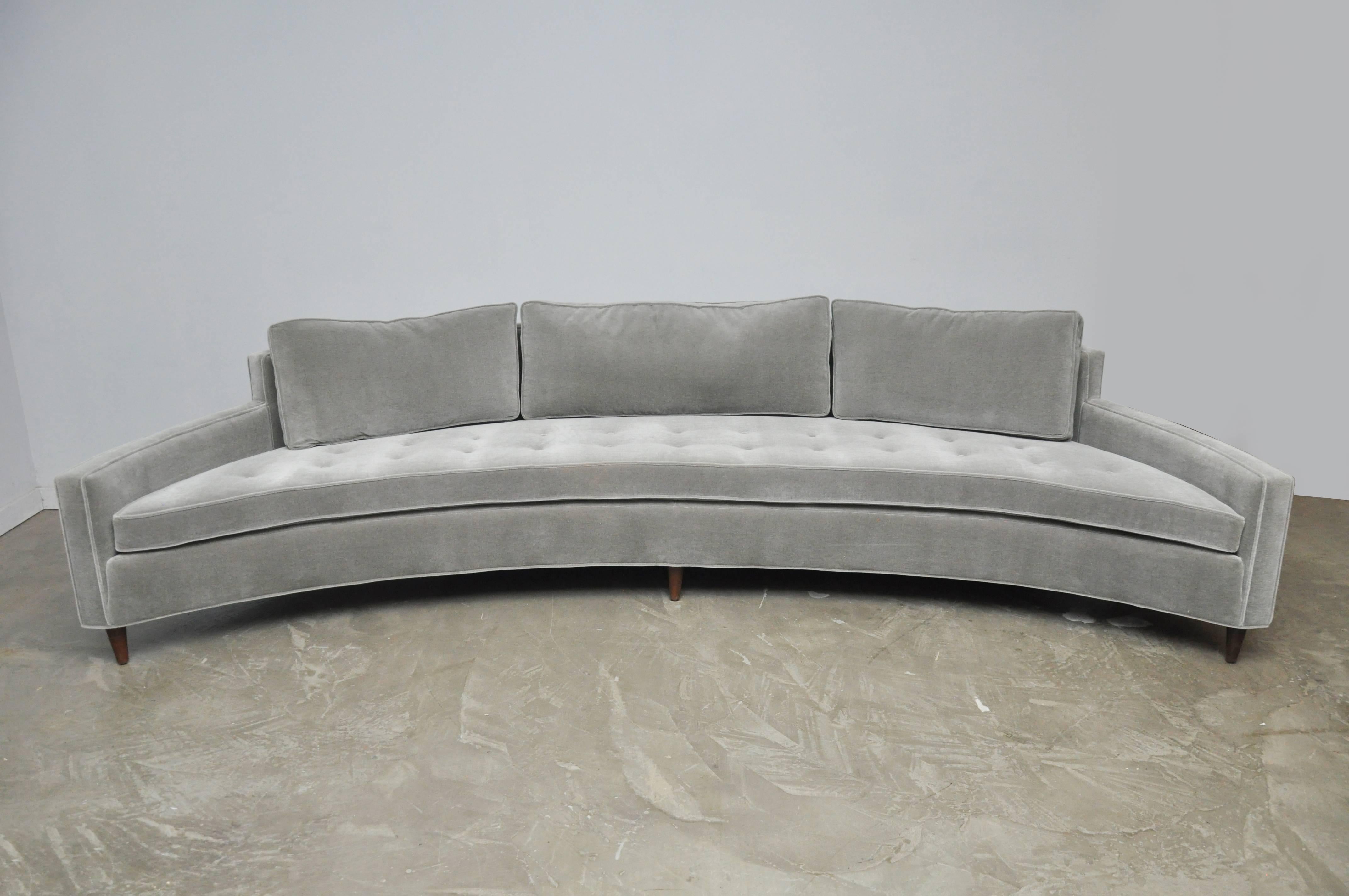 A large curved sofa designed by Harvey Probber. Fully restored. Reupholstered in smoke grey mohair over refinished espresso tone legs.