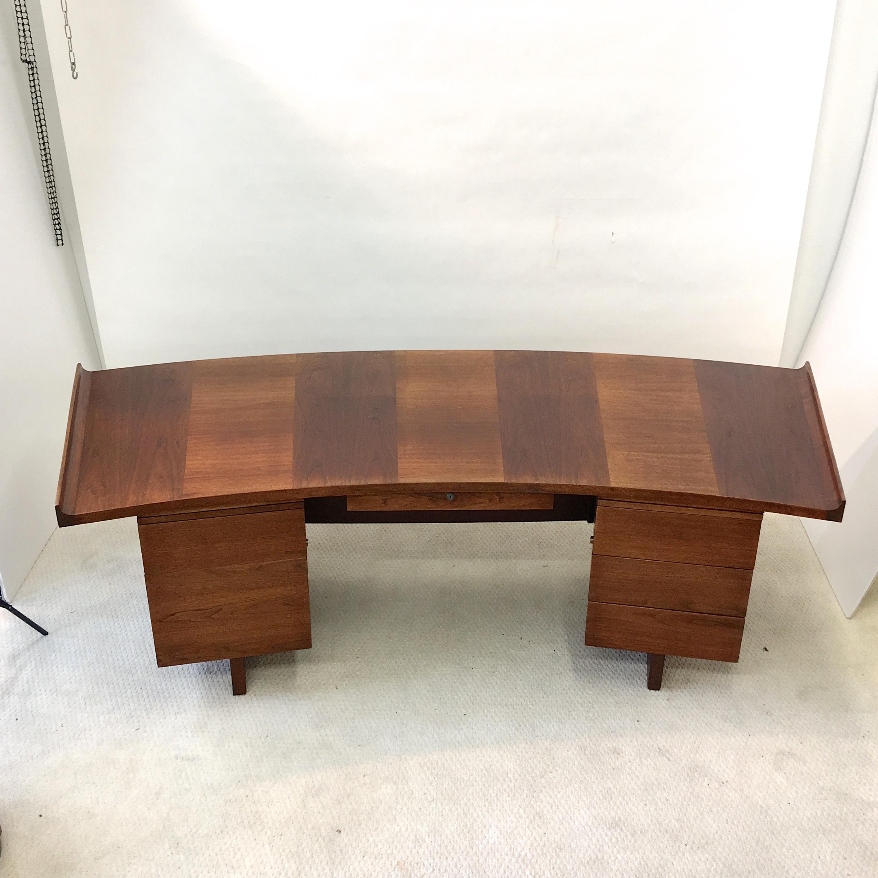Monumental curved top executive desk in walnut by Harvey Probber.
This is the largest version of Probber's curved top desk made. 92