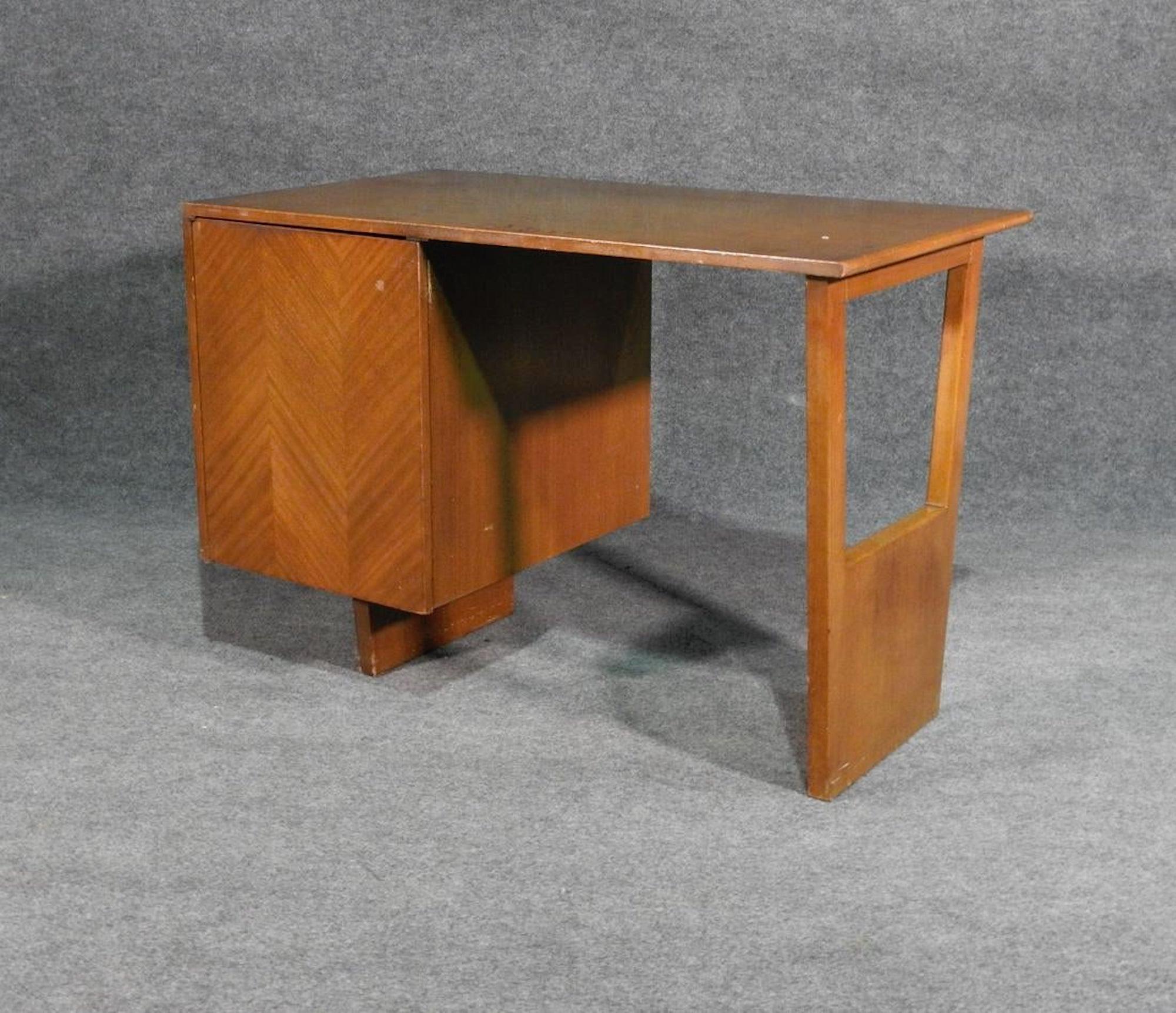 Mid-Century Modern writing desk by Harvey Probber with patterned front cabinet and concealed drawers.
(Please confirm item location - NY or NJ - with dealer).
   
