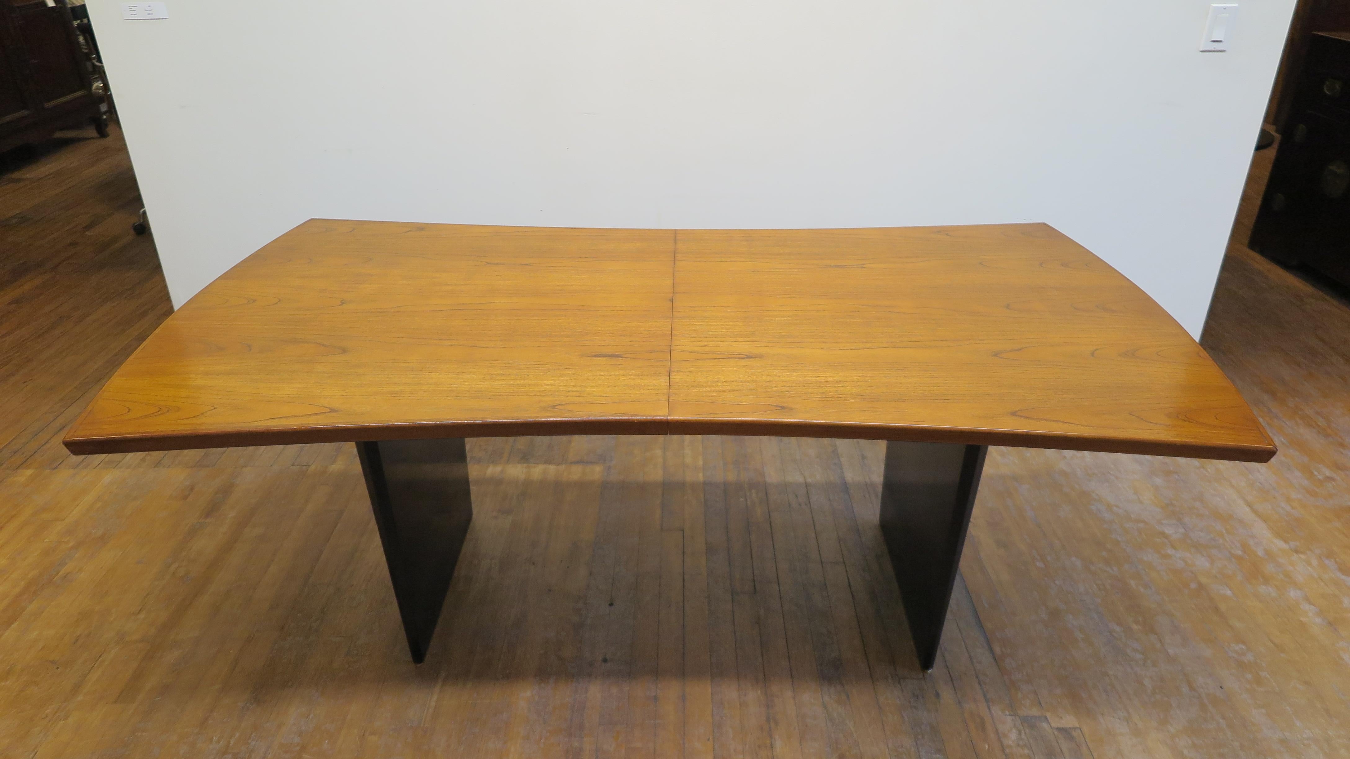 Harvey Probber bow tie dining table. Mid-Century Modern dining table by Harvey Probber in the shape of a Bow Tie. Teak top with walnut legs having a solid brass glide bar on the bottom of each leg. Table is 78 inches long closed two additional