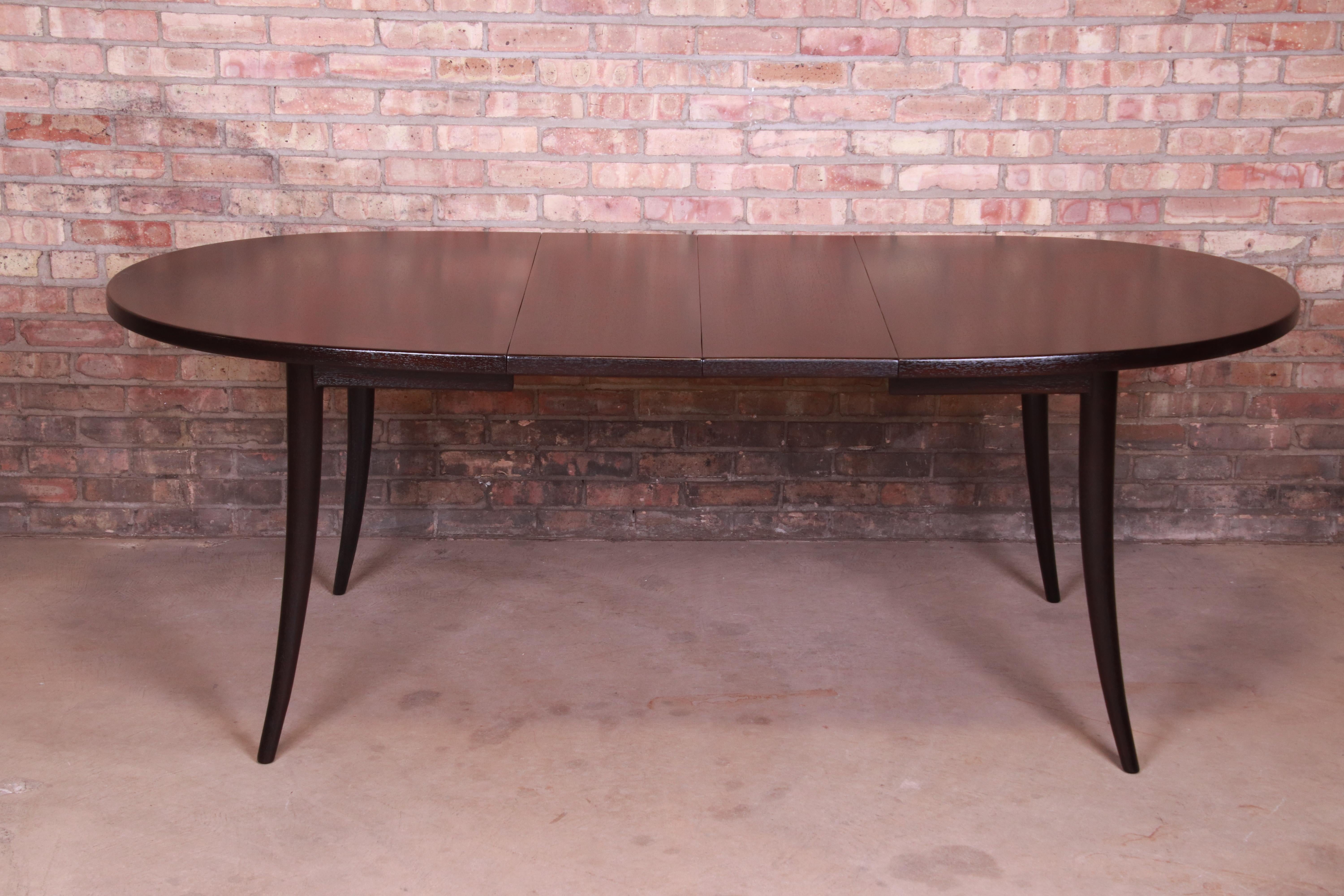 An exceptional Mid-Century Modern ebonized mahogany saber leg extension dining table

By Harvey Probber

USA, 1950s

Measures: 56