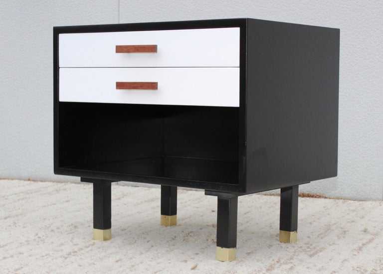 Stunning 1960s Mid-Century Modern end table designed by Harvey Probber, with two drawers and brass and walnut hardware and brass sabots.