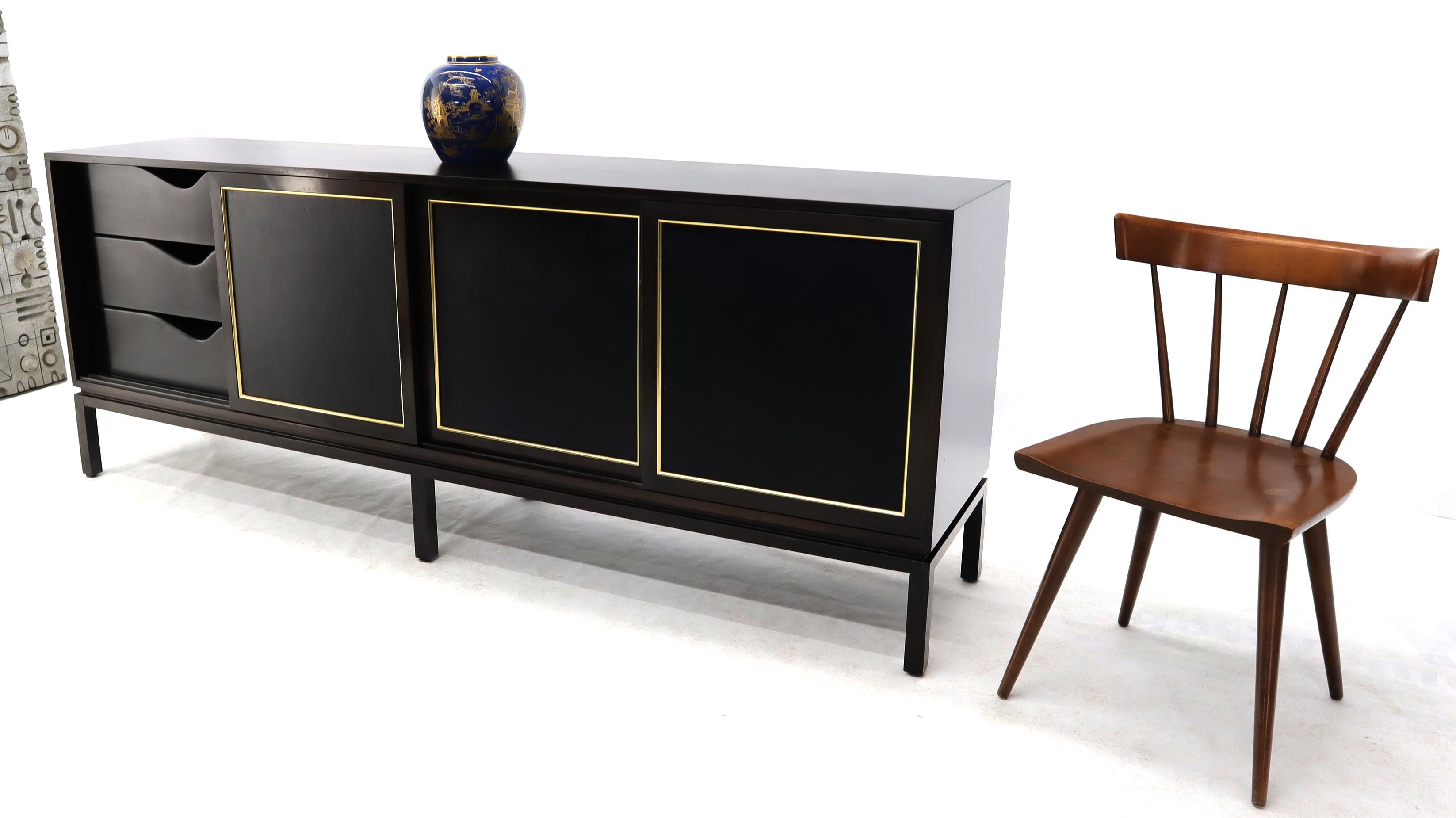Mid-Century Modern 4 brass and leather sliding doors 12 drawer long credenza by Harvey Probber. Very sharp looking piece in excellent vintage condition.