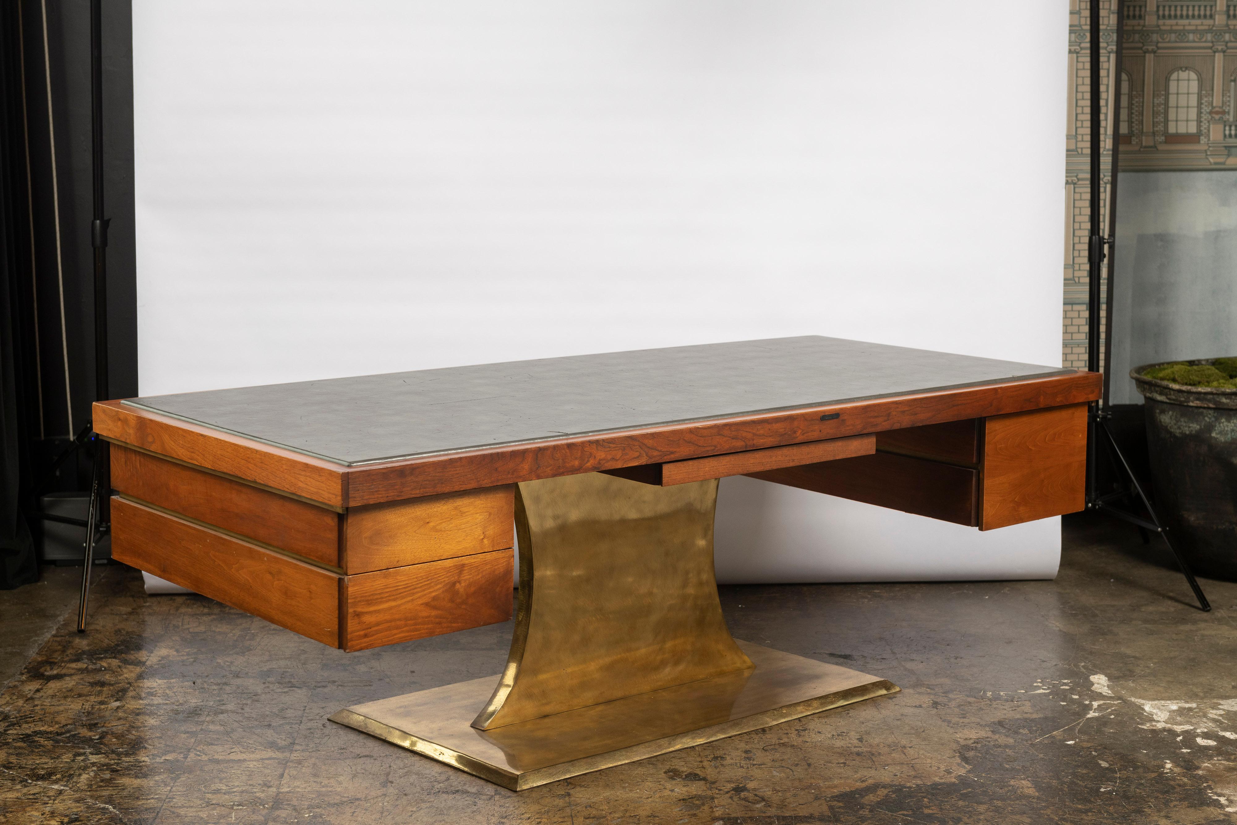 Rare monumental desk by Harvey Probber in walnut, brass, metal fittings and leather inlaid top. Significant statement piece for an executive setting or for someone who appreciates scale and materiality. The top, two side drawers, center drawer and