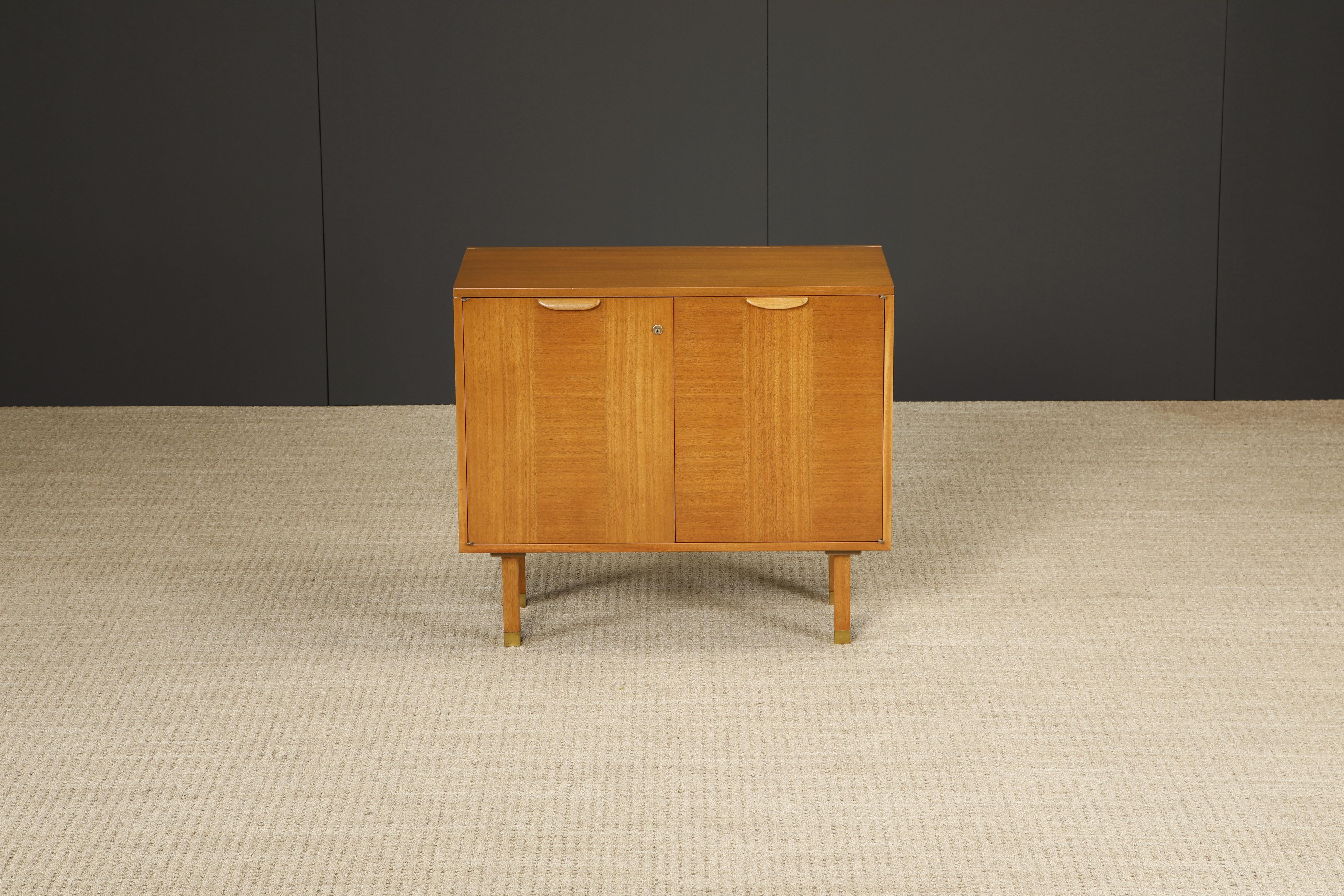 This unique flip-top bar cabinet by Harvey Probber, circa 1950s, is packed full of useful features and is beautifully crafted from bleached Mahogany, doors with contrasting grain which elevates this piece stylistically, and capped with brass sabots.