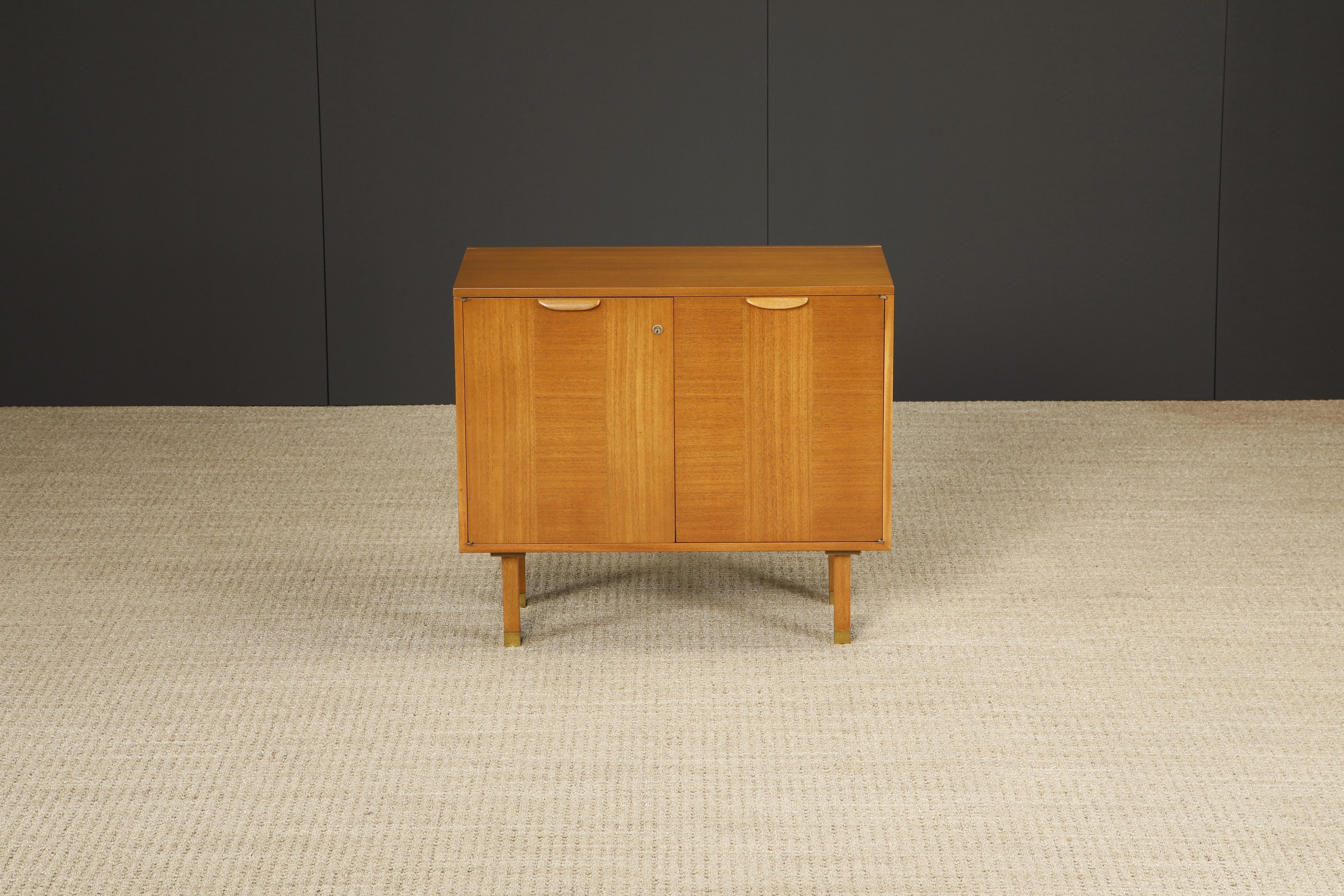 This unique flip-top bar cabinet by Harvey Probber, circa 1950s, is packed full of useful features and is beautifully crafted from bleached Mahogany, doors with contrasting grain which elevates this piece stylistically, and capped with brass sabots.