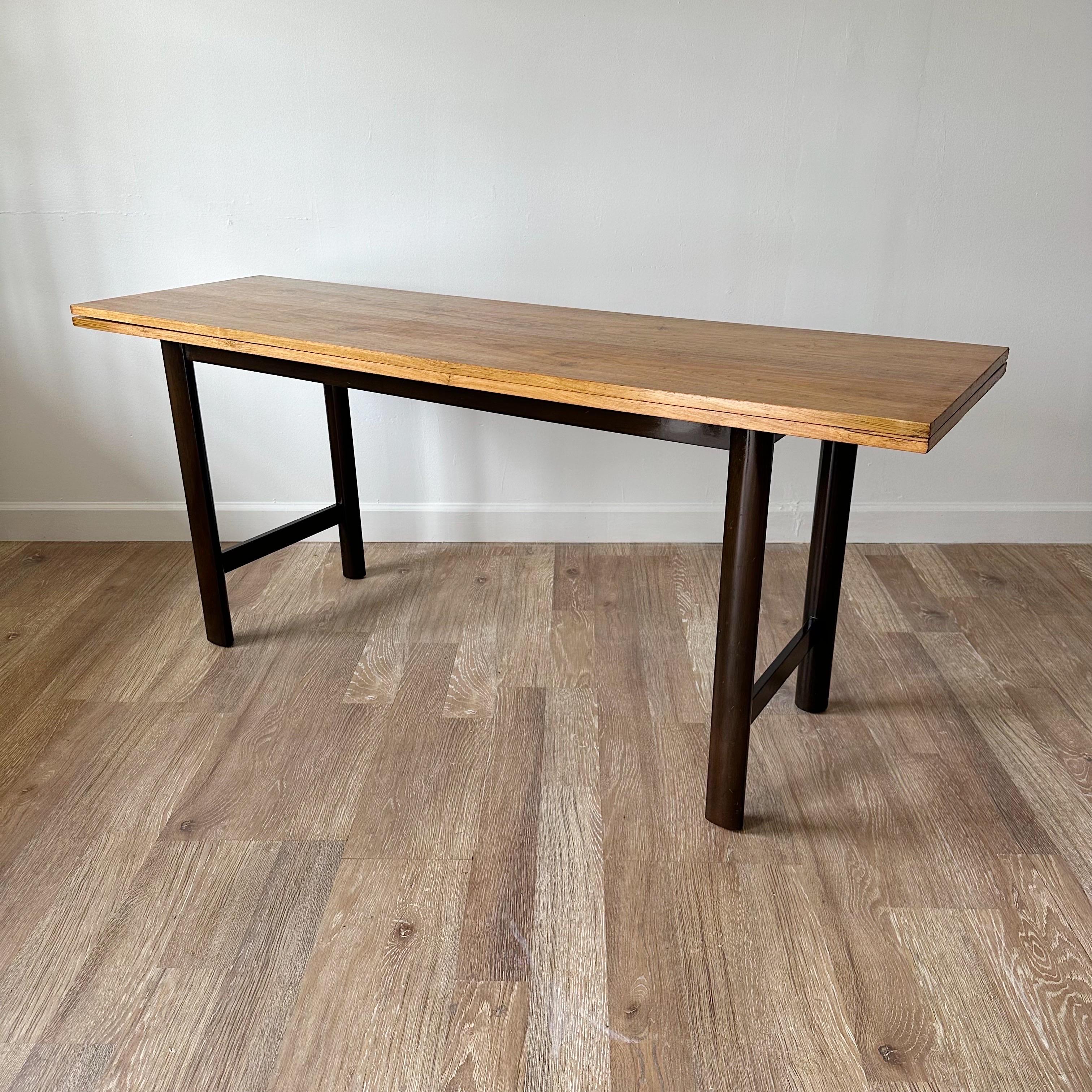 Versatile flip-top console table to be used as console or small dining table. 20 inches deep closed,opens to 40 inches. Table surface with stunning  rosewood with ebonized walnut legs.