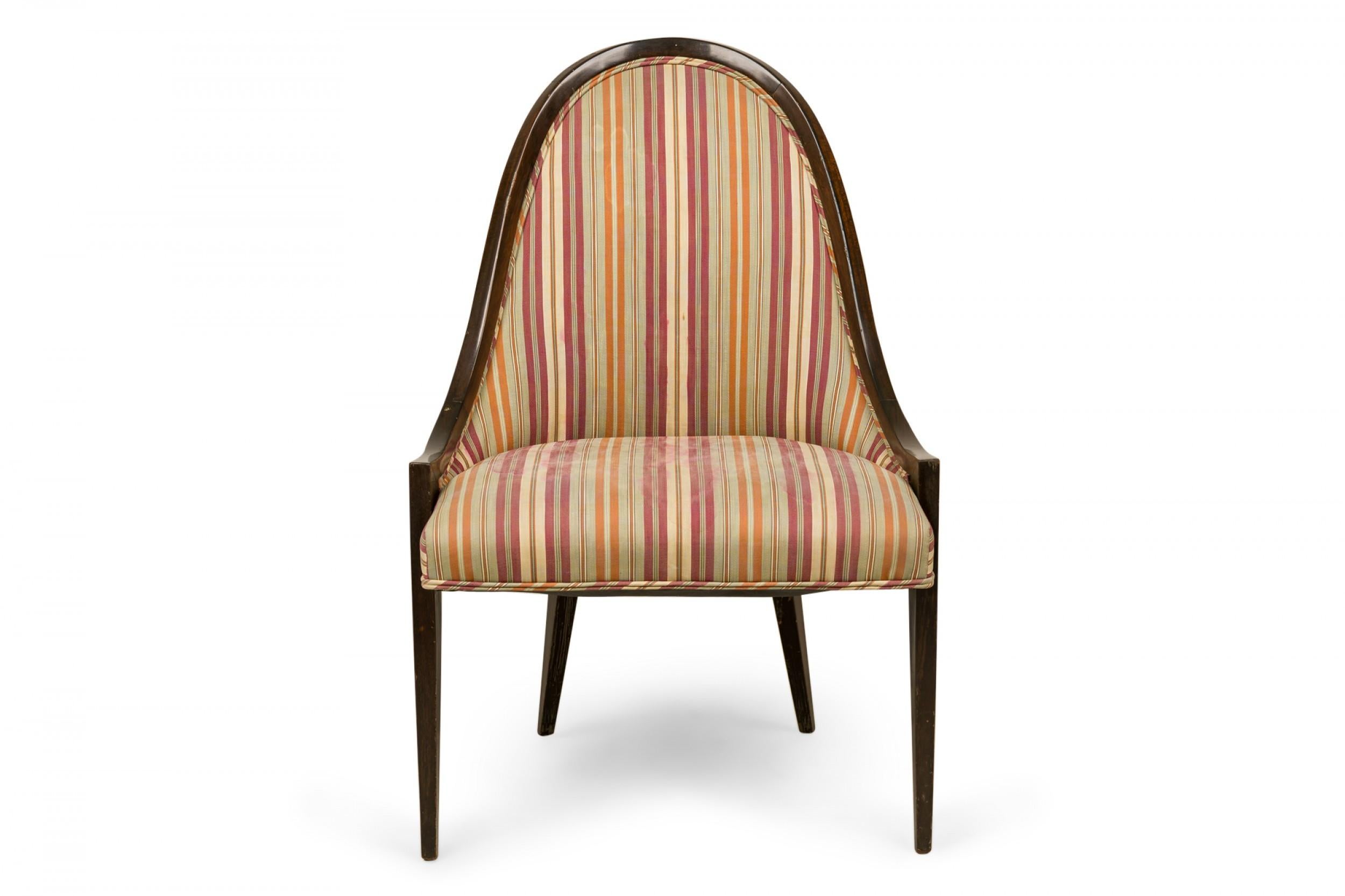 American mid-century 'Gondola' form chair with a curved dark stained wooden frame and muted pink, green, and beige vertically striped upholstered seat and back, resting on four tapered wooden legs. (HARVEY PROBBER)
 