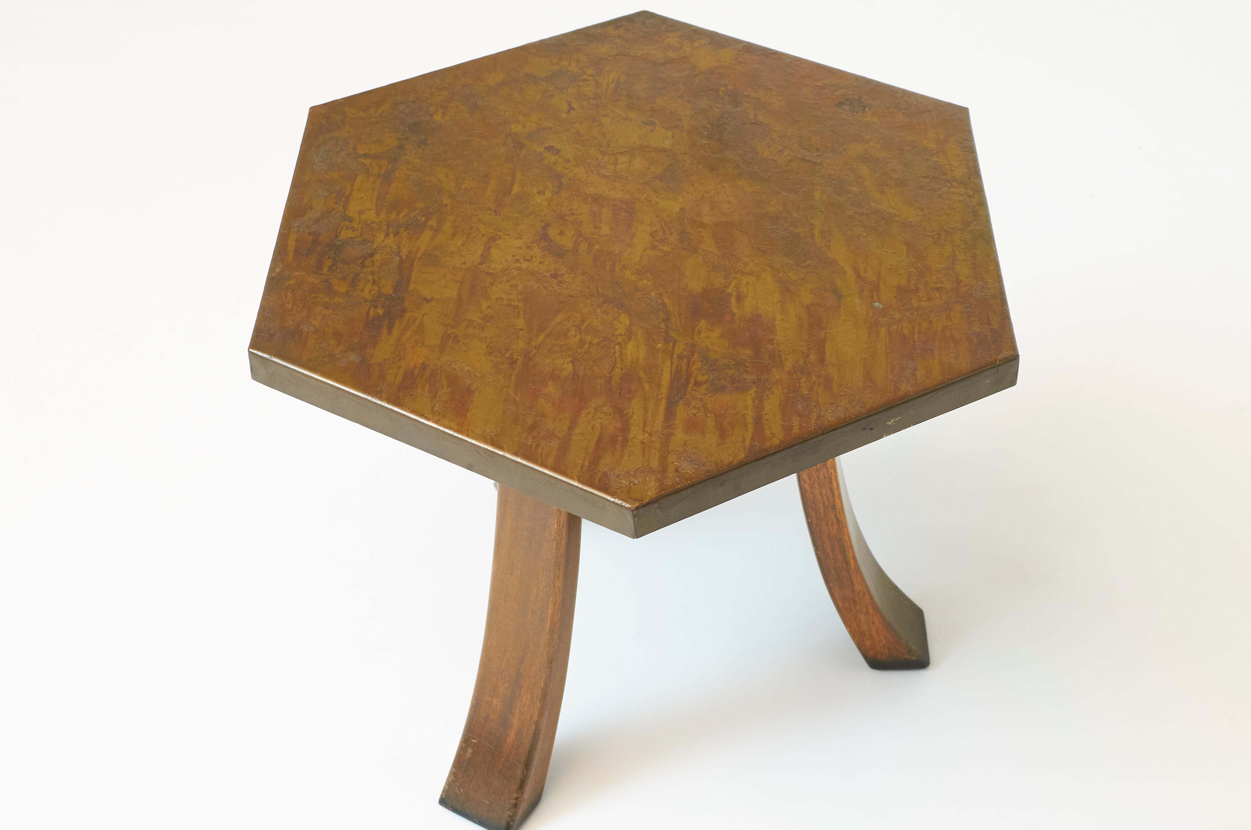 A pair of patinated bronze hexagon shaped side tables with tripod base of splayed wood legs.