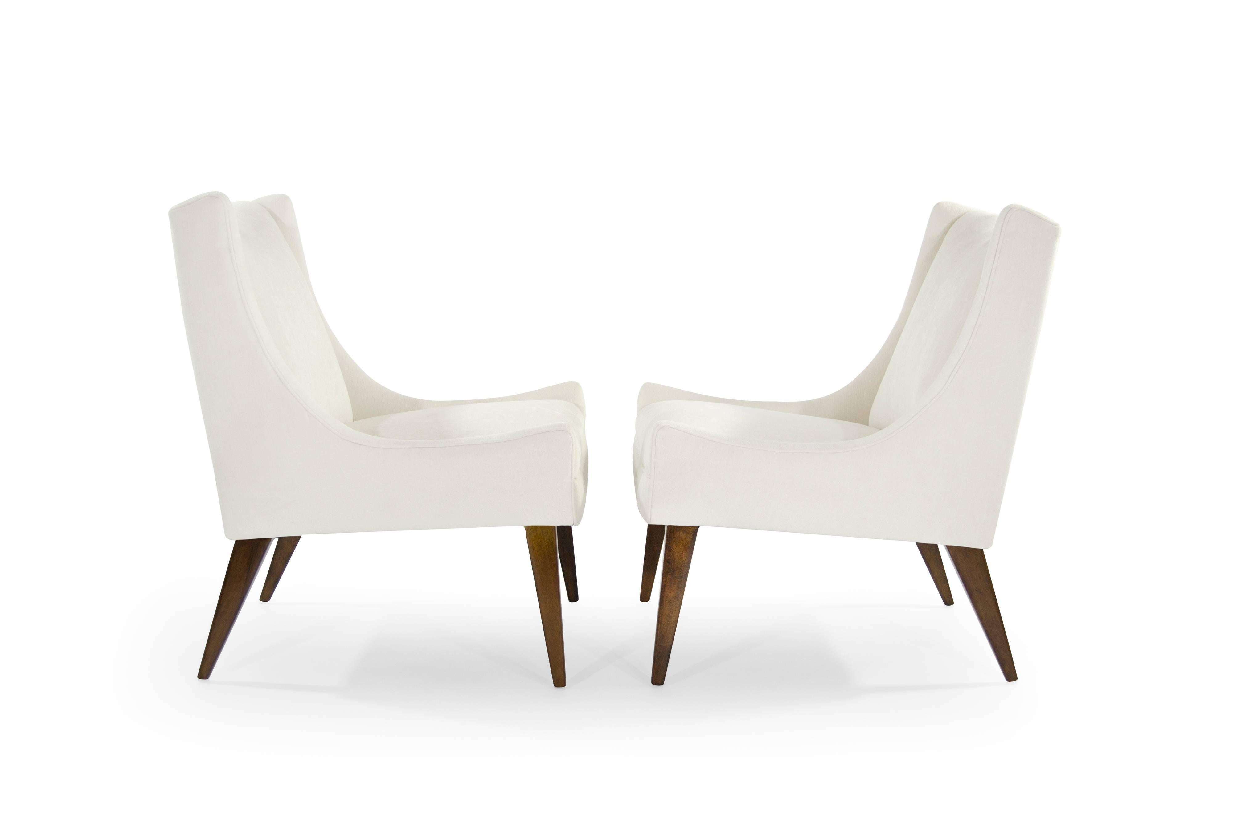 Set of slipper chairs by Selig, circa 1950s. Newly upholstered in a soft ivory velvet. Walnut legs fully restored. Brass handle detail hand polished.