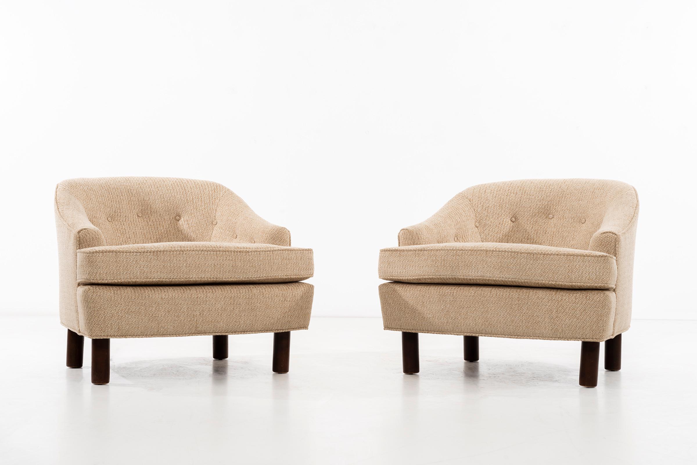 Pair of barrel back lounge chairs with pincore foam cushions. Solid walnut legs.