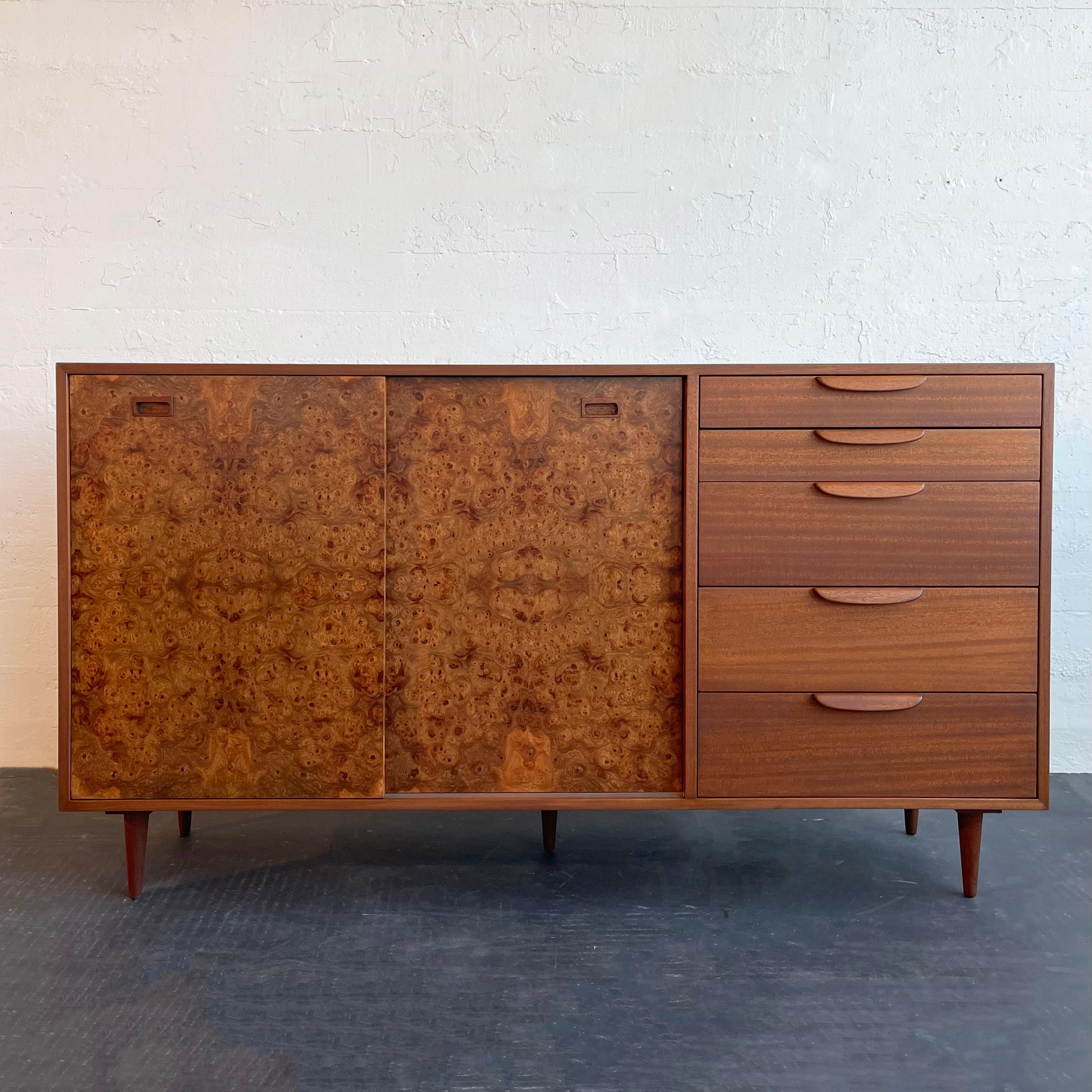 Mid-century modern, sideboard / credenza / dresser by Harvey Probber features a mahogany case and drawers with diamond-matched, walnut burl sliding doors. The interior features white lacquered pull-out drawers and shelves. This gorgeous case piece