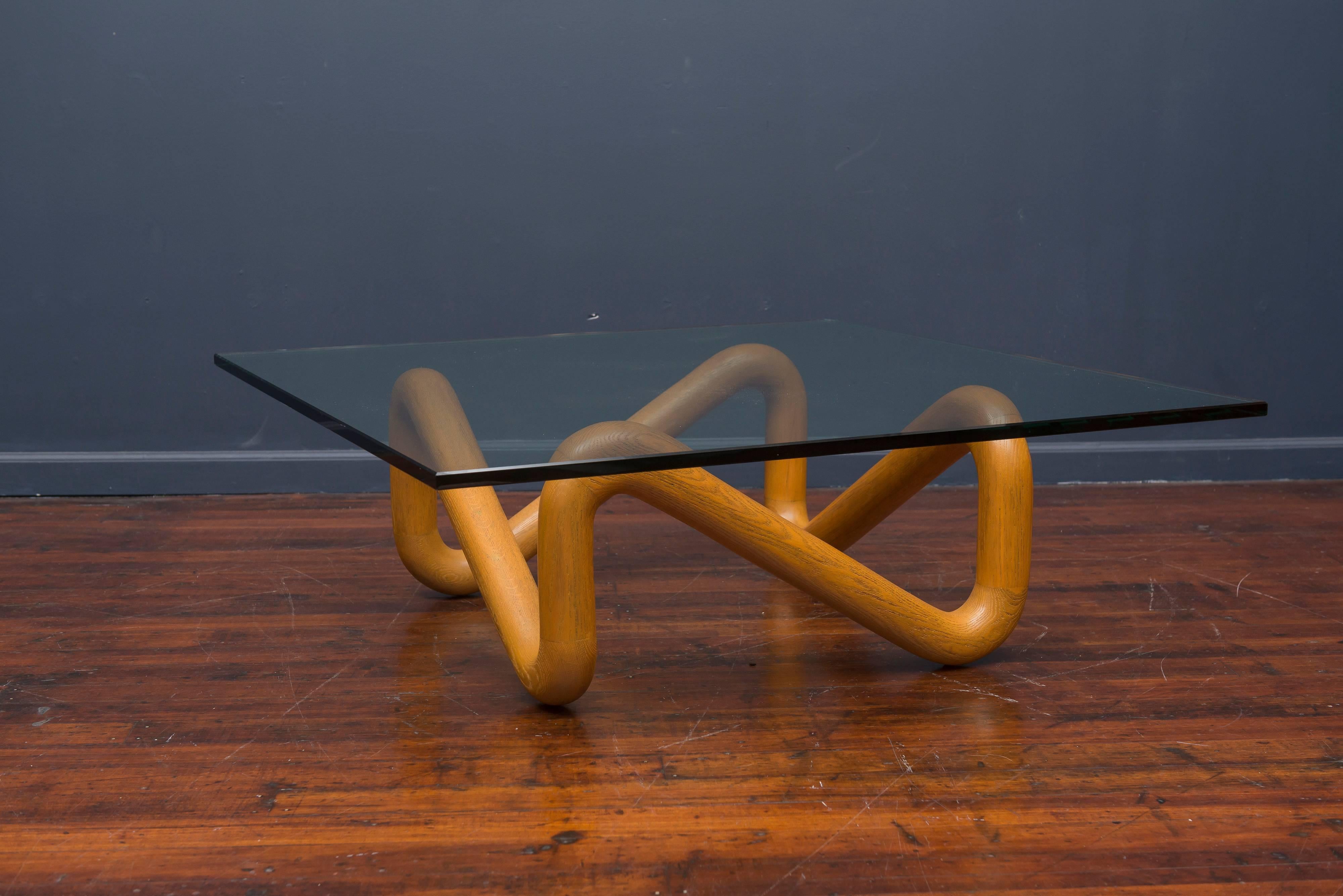 Rare sculptural coffee table designed by Harvey Probber. Made from knotted oak with a square glass top.