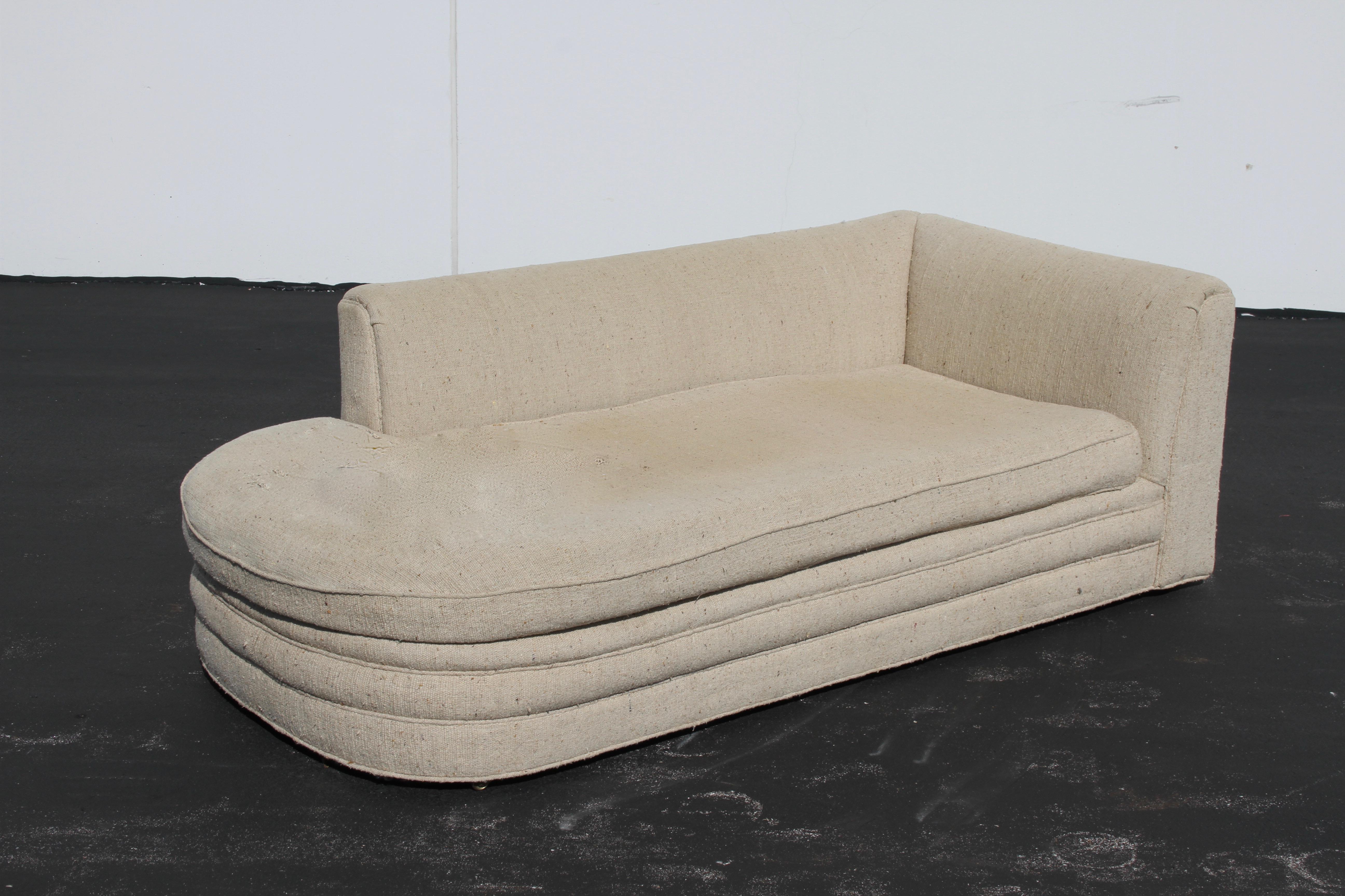 Harvey Probber Classic midcentury, open end sofa or chaise with ottoman on small brass castors. This sofa seems to have been re-upholstered in the late 1980s or early 1990s, but is in need of re-upholstery again. The fabric on the seating area is