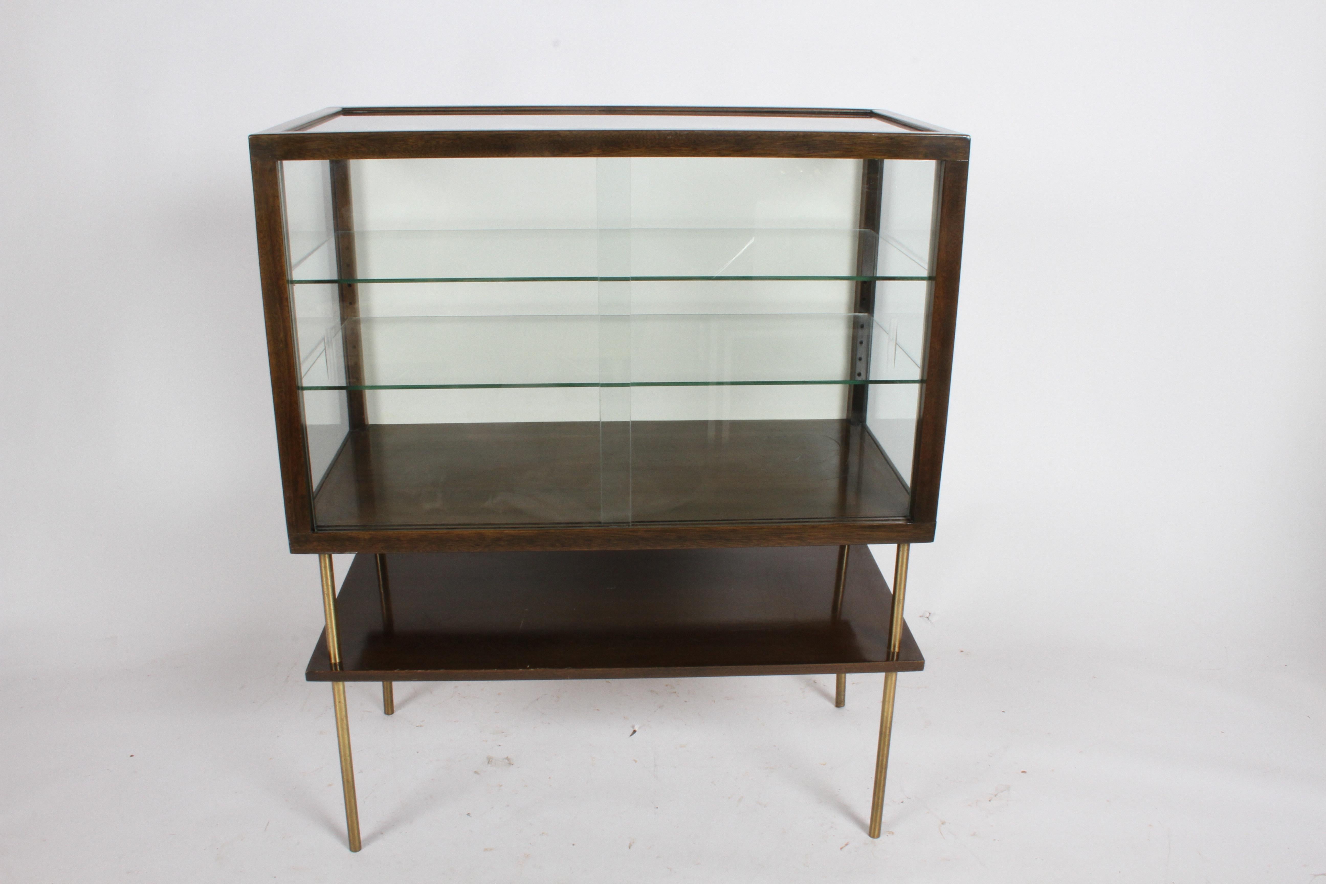 Rare Harvey Probber curio display case on brass legs. Can be used to display your collections or even used in a store setting to sell items. Also can be used as a bar to display your glassware , shakers etc. Has two sliding doors with cut recessed