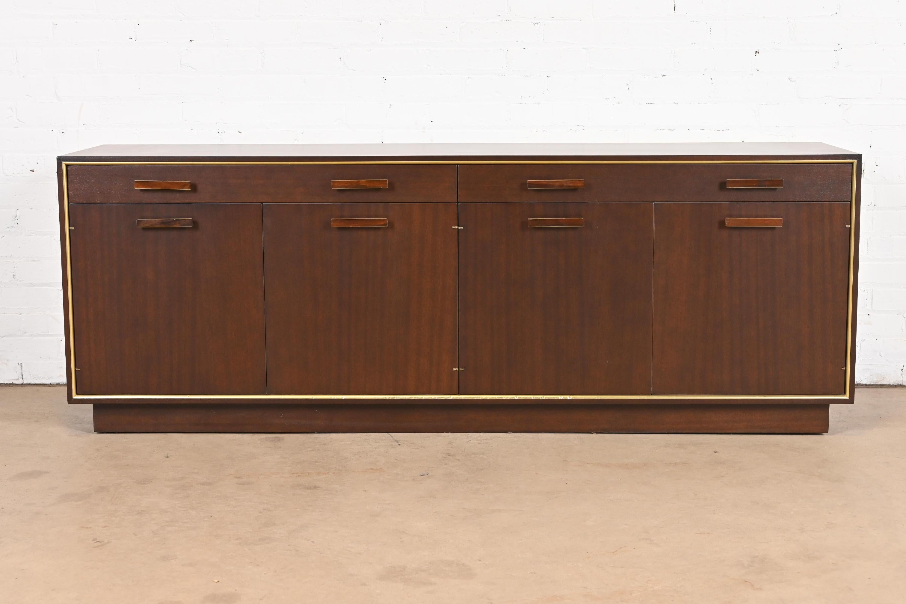 A gorgeous Mid-Century Modern low sideboard, credenza, or bar cabinet

By Harvey Probber

USA, 1950s

Beautiful mahogany, with brass trim, and rosewood and brass hardware.

Measures: 71.25
