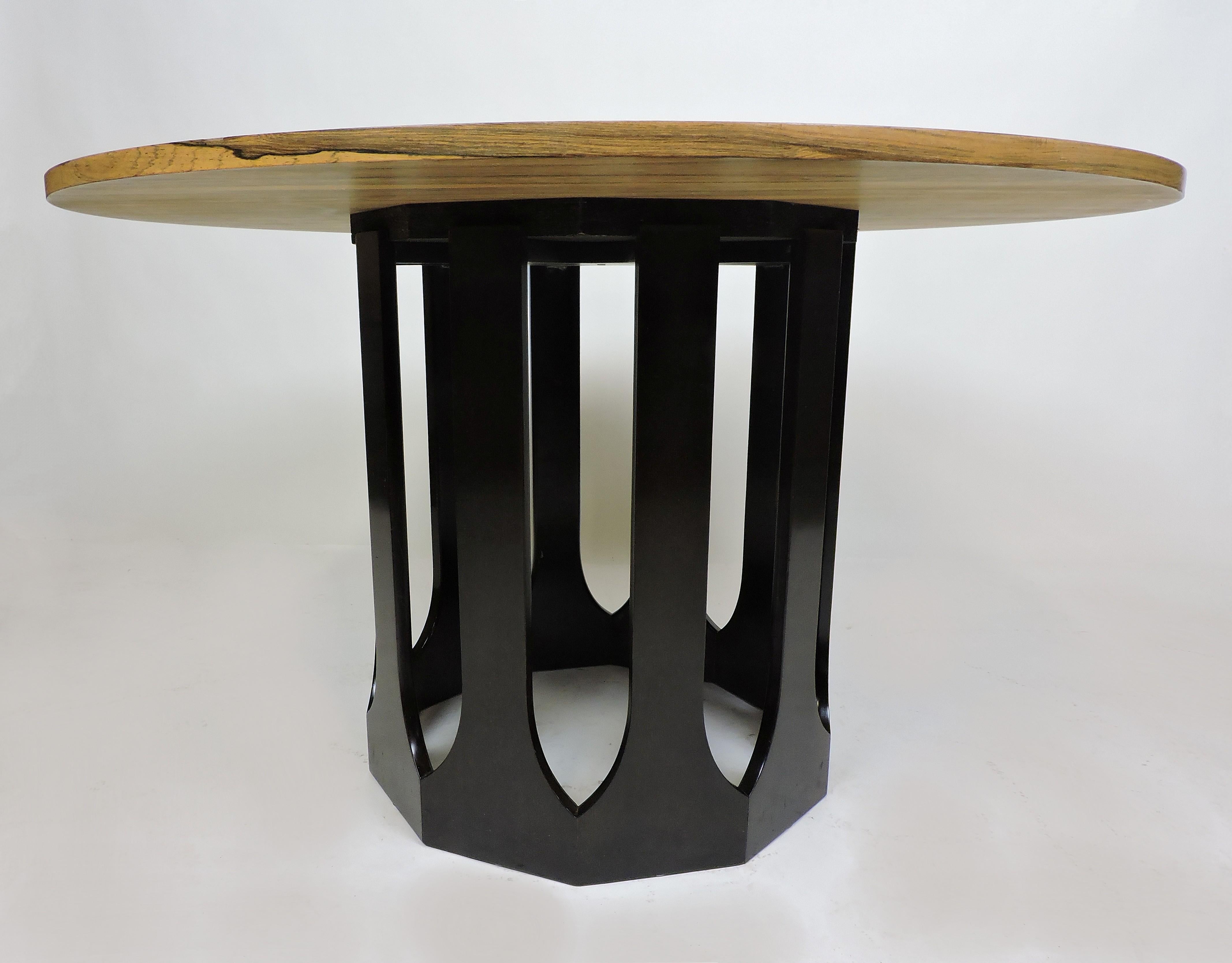 Elegant looking dining, breakfast, or game table designed by Harvey Probber. This table has a round top with a sculptural ebonized wood base. Can easily seat four.
  