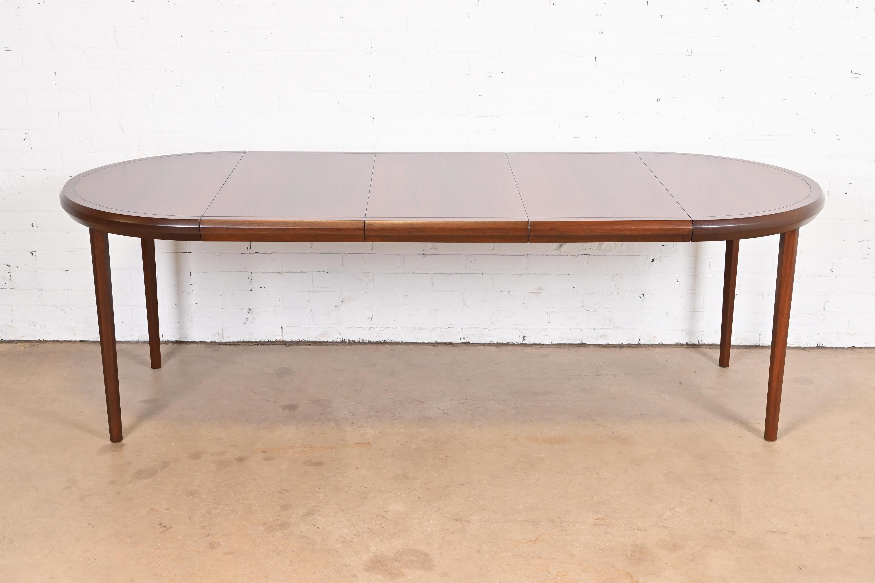 An exceptional Mid-Century Modern extension dining table

By Harvey Probber

USA, 1960s

Gorgeous book-matched rosewood top, with solid rosewood legs.

Measures 38