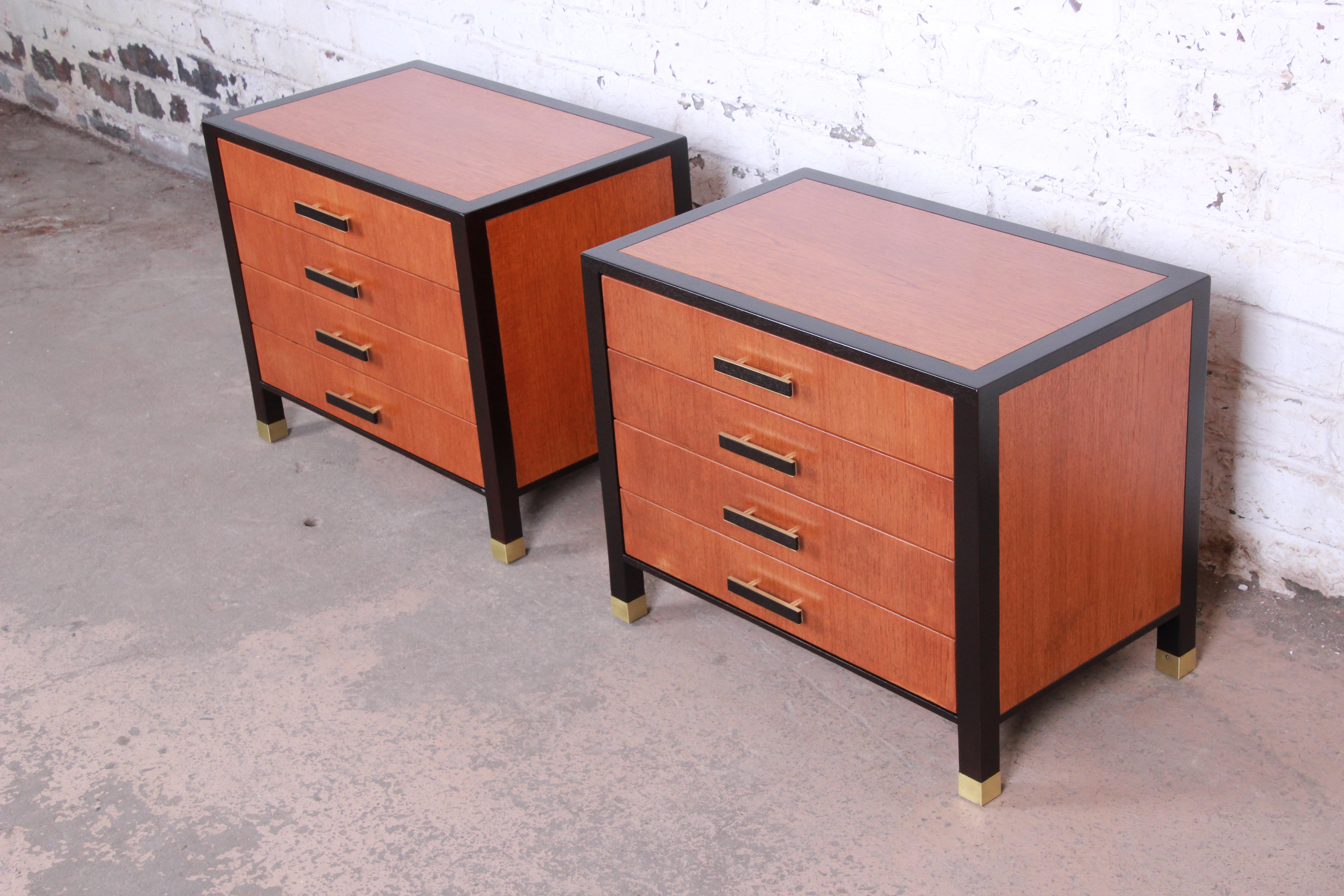 An exceptional pair of Mid-Century Modern nightstands designed by Harvey Probber. The nightstands feature gorgeous teak wood grain with mahogany banding and brass-capped feet. They offer ample storage, each with four dovetailed drawers with the