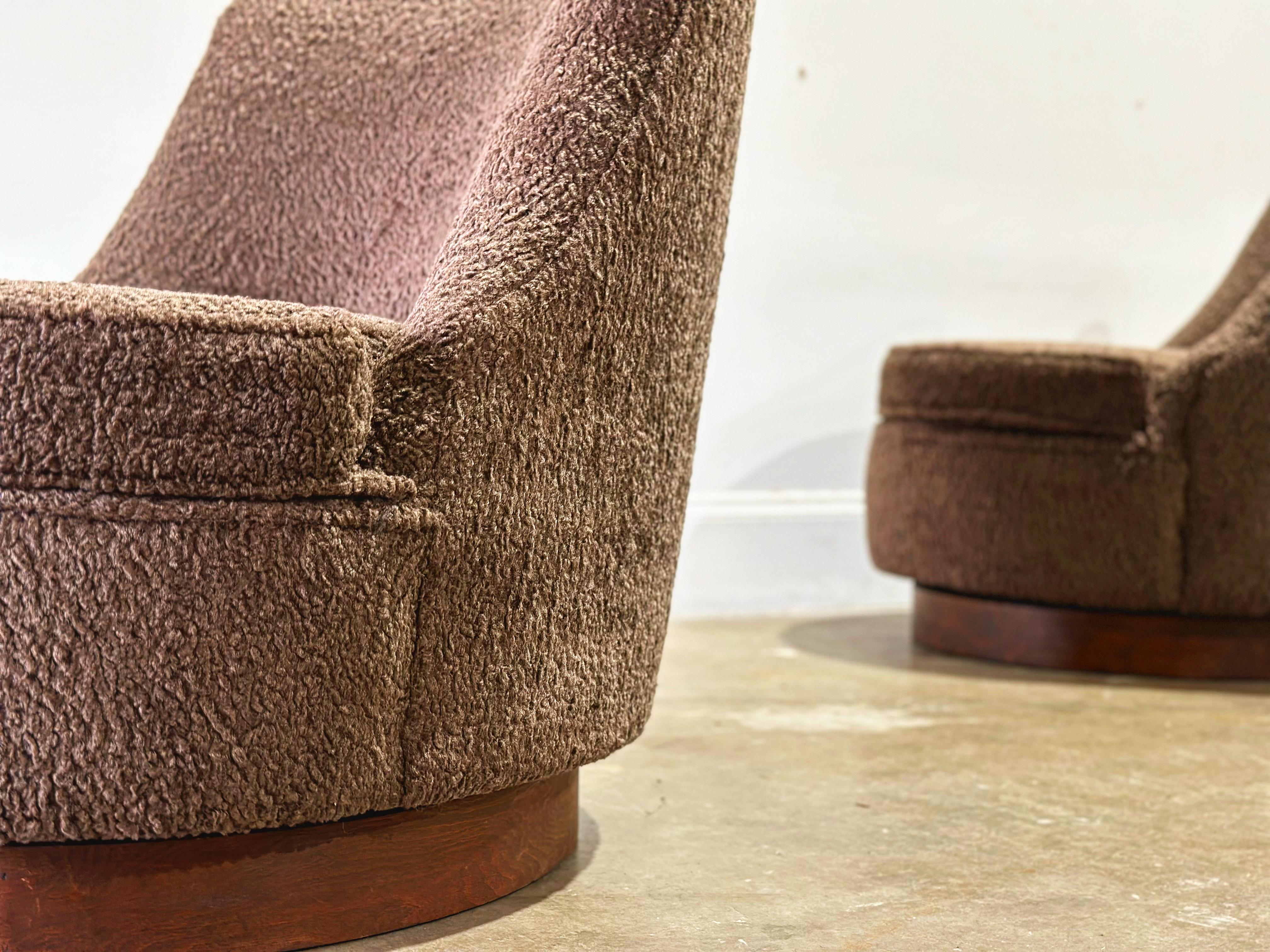 Pair of stunning Mid-Century Modern swivel slipper style barrel chairs with walnut plinth bases by Harvey Probber. Ultra soft sherpa boucle in a warm chocolatey brown - kind of like sitting in a giant teddy bear! 
All new foam, strapping and