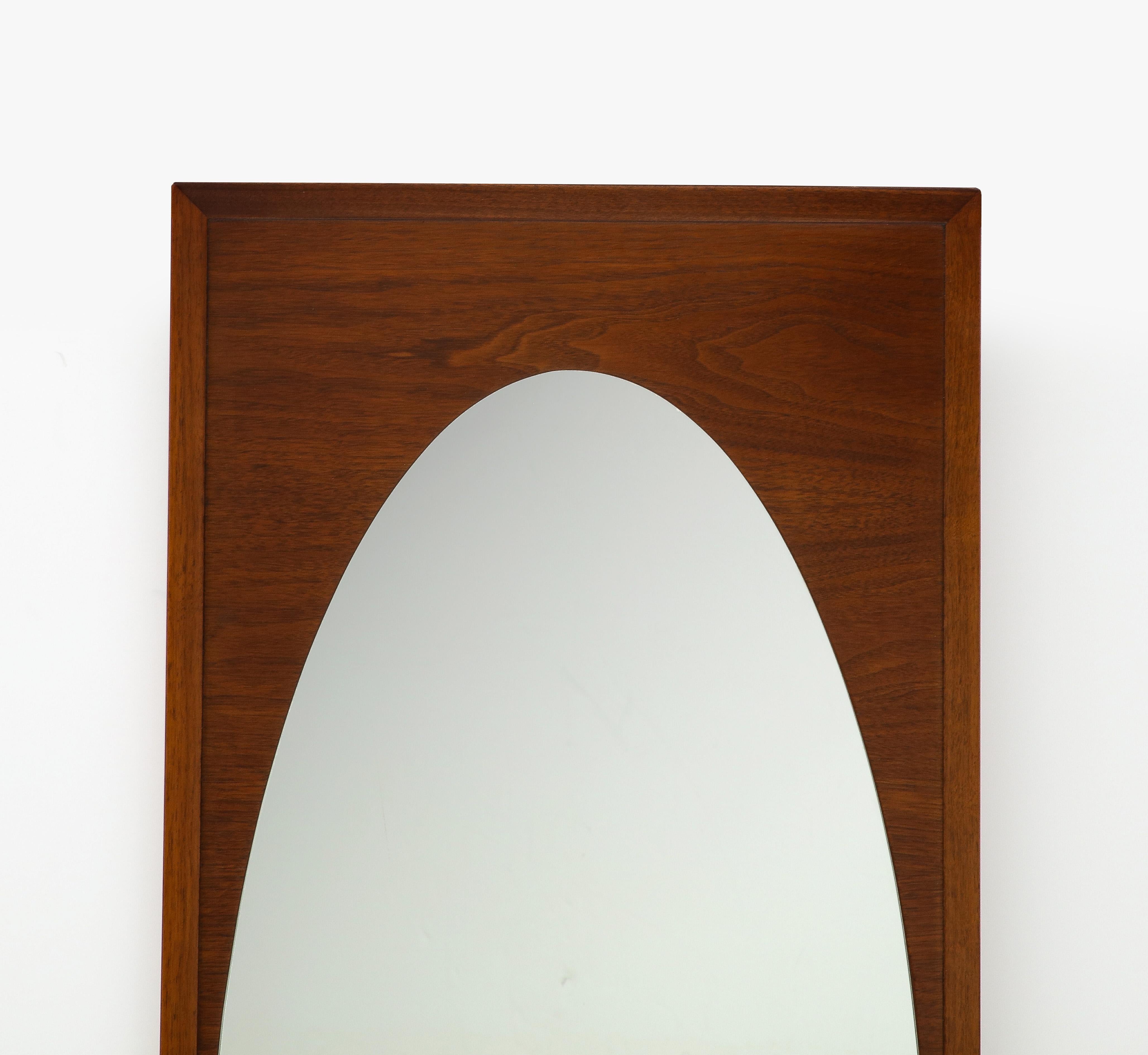 Beautiful 1960's modernist walnut frame with Elliptical oval mirror designed by Harvey Probber, in very good vintage condition, lightly restored with minor wear and patina due to age and use.