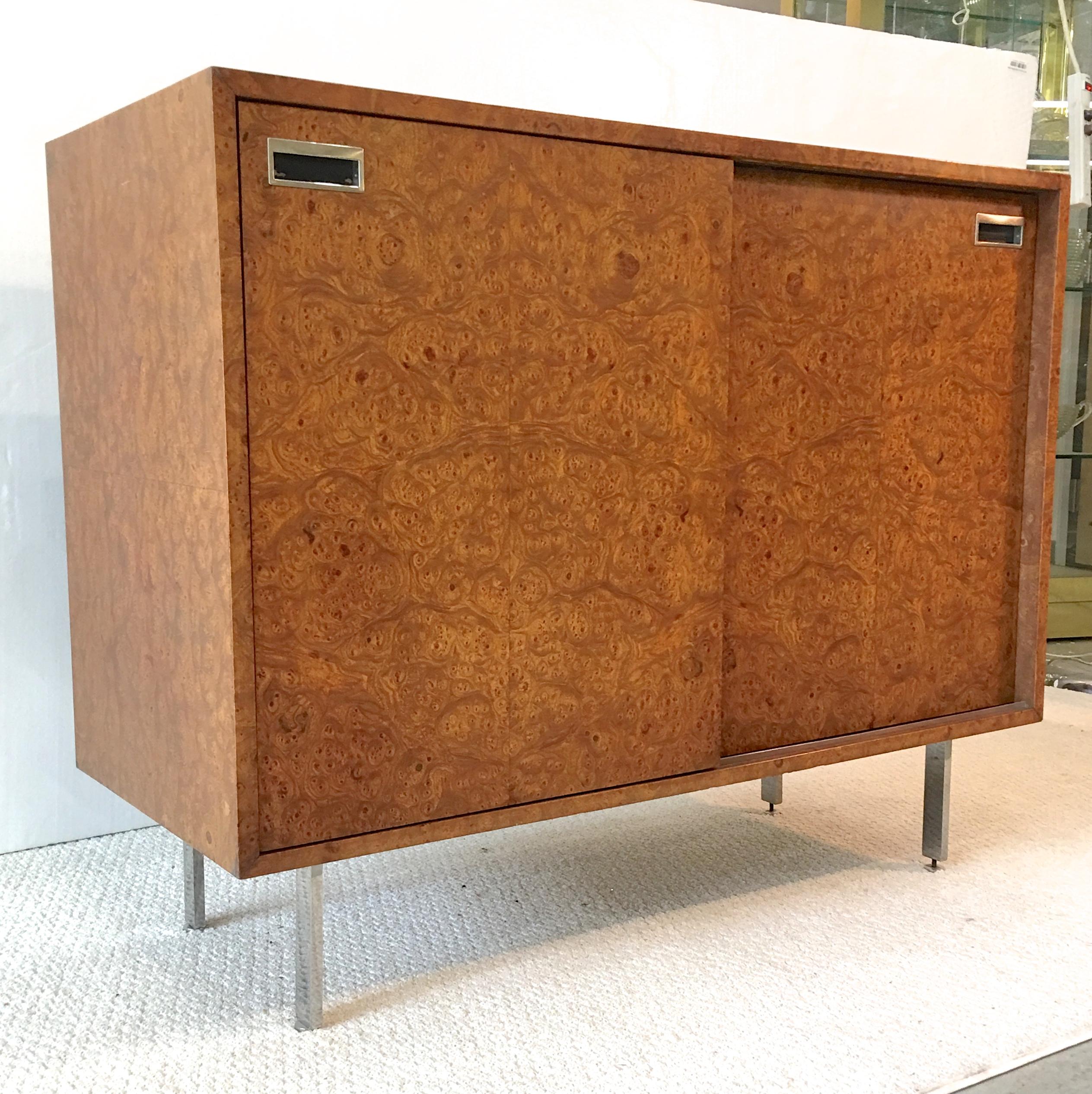 SATURDAY SALE Oct. 2018

Sublimely chic dressing cabinet by Harvey Probber. Olive burl rectangular case with double sliding doors on stunning polished aluminum legs with round levelers. Sliding doors have inset chrome handles with black enamel.
