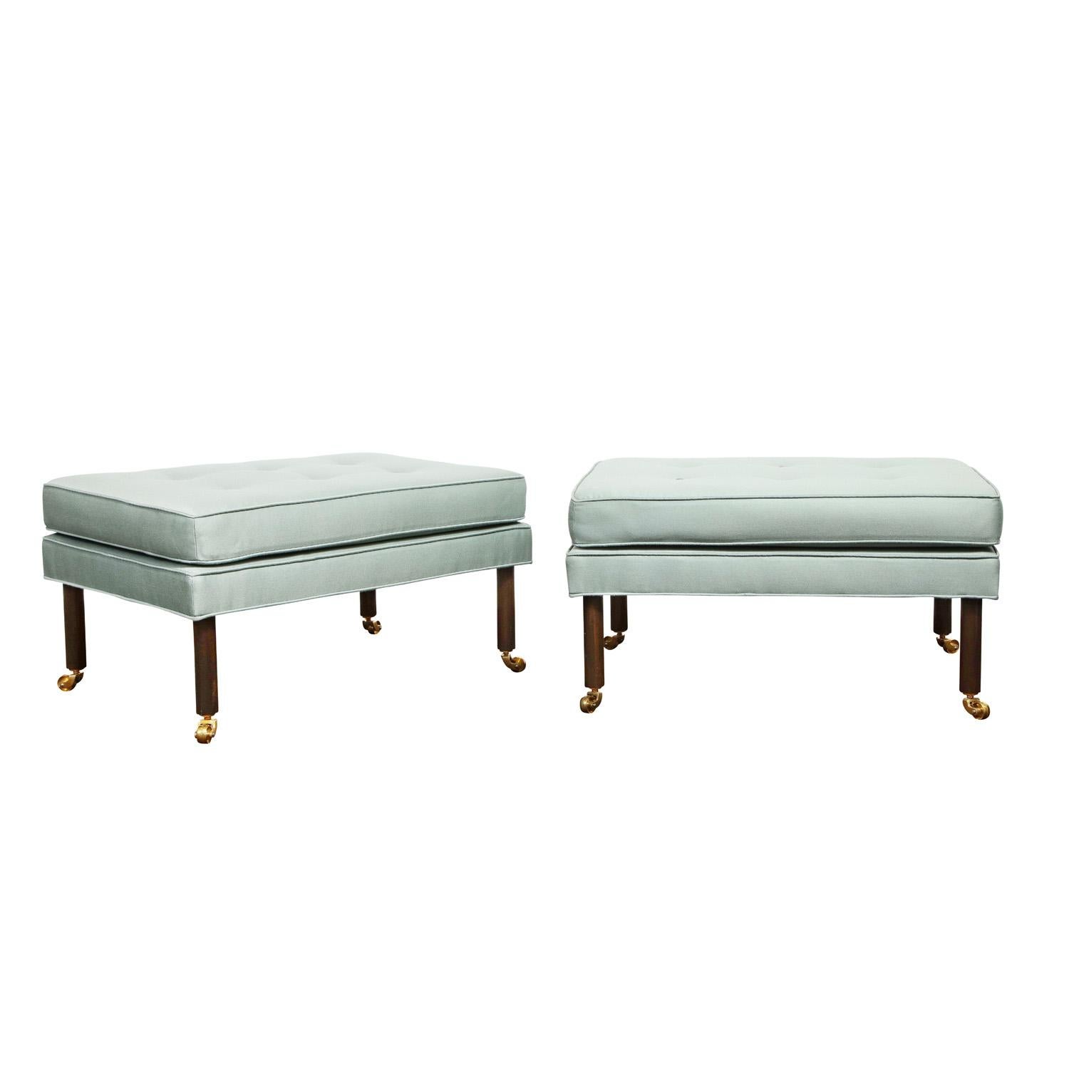 Chic pair of rectangular upholstered benches with round mahogany legs and brass castors by Harvey Probber, American 1950's. Refinished and reupholstered by Lobel Modern.