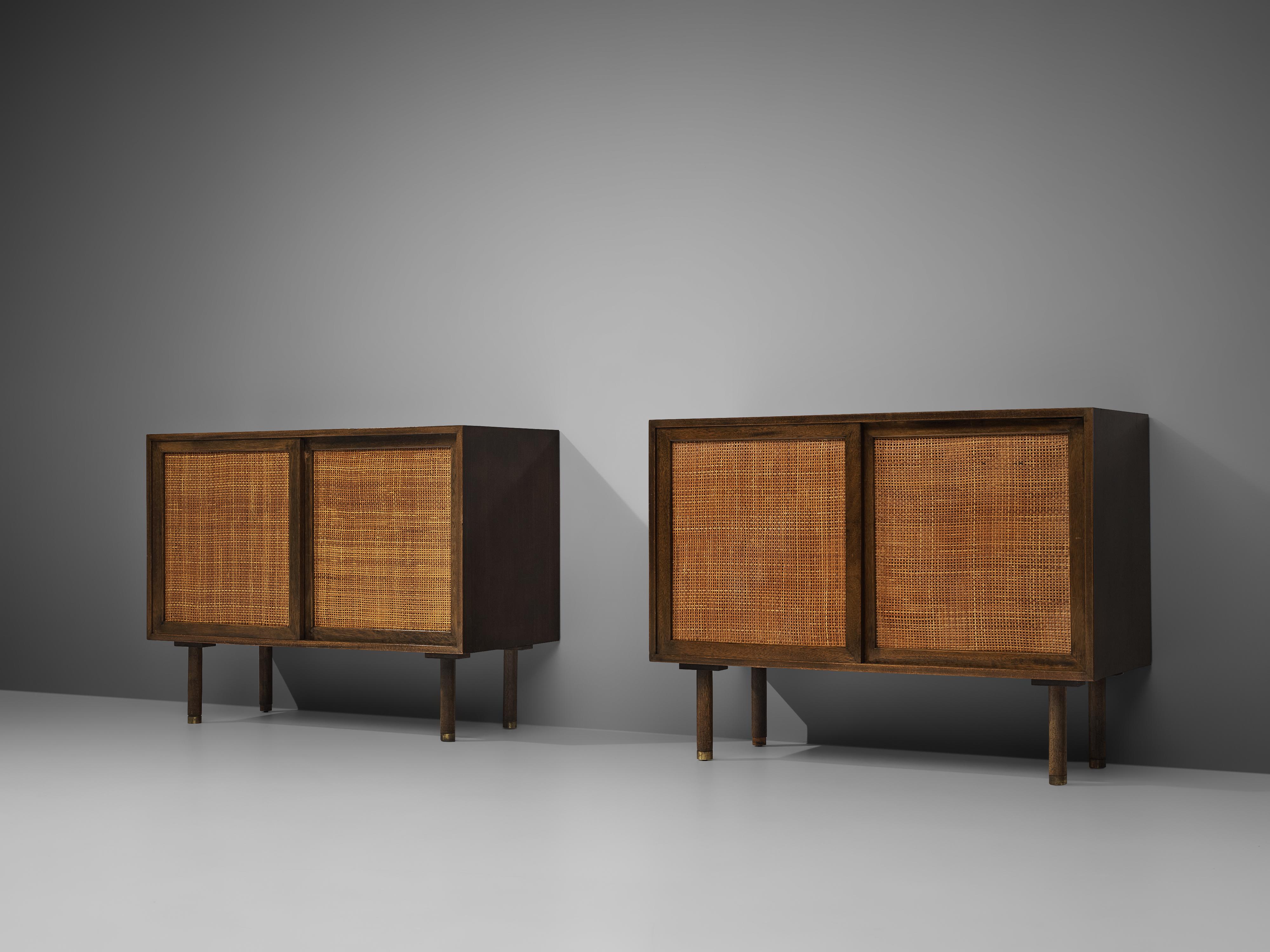 Harvey Probber, pair of cabinets, mahogany, cane, brass, United States, 1950s

Pair of cabinets in mahogany with cane doors by American designer Harvey Probber. These two small cabinets give a stunning appearance. They cubic form on thin round